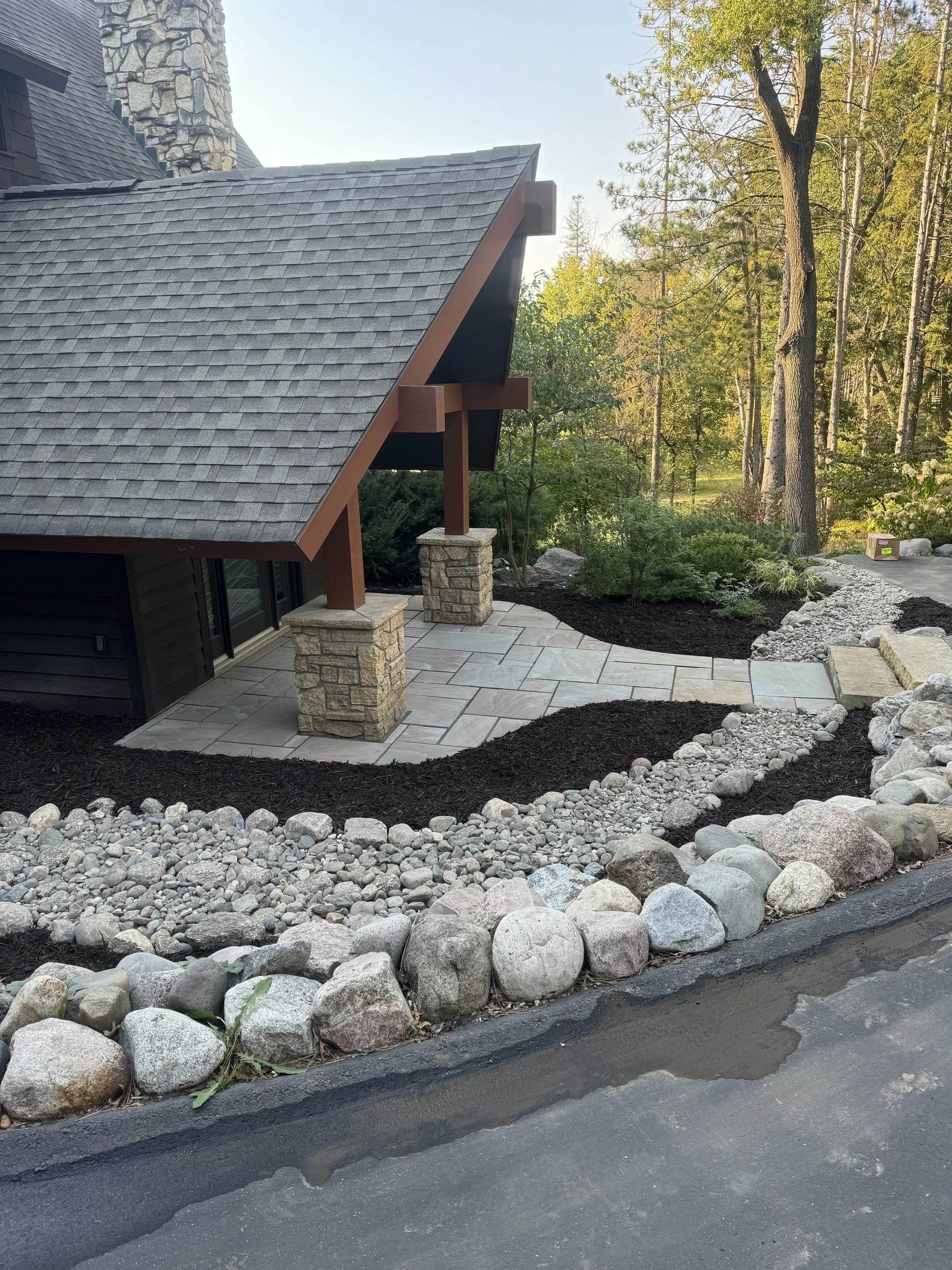 MB Landscapes installed a landscaped pathway with dry creek bed, boulder retainage and mulch.