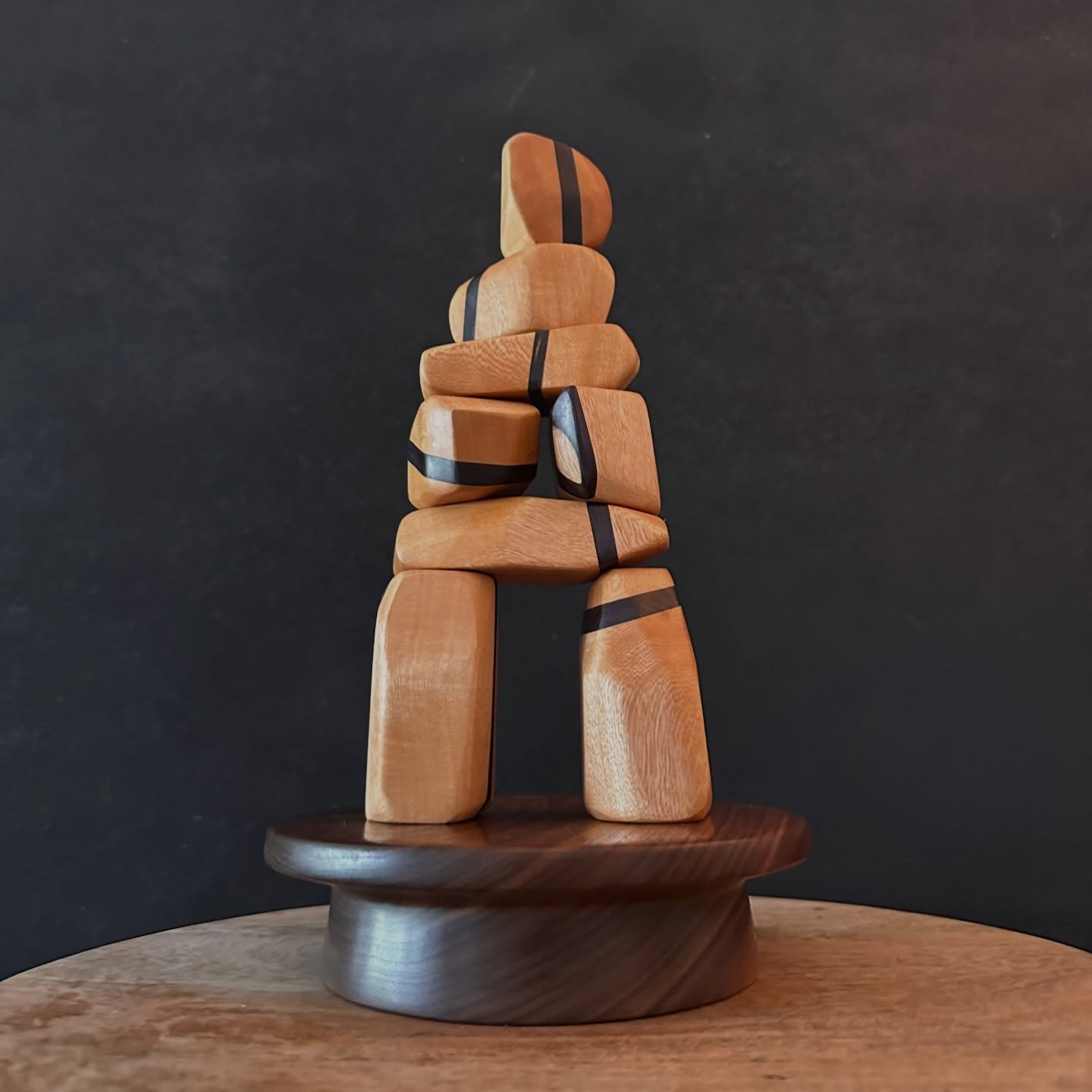 Deep dyed blue and purple sassafras slices are wrapped between pieces of Jacaranda in this truely one of a kind Inukshuk/stacking rocks set!

Positioned on a sturdy hand turned walnut base, this set sits proud.

Stack them however you see fit, it&rsq