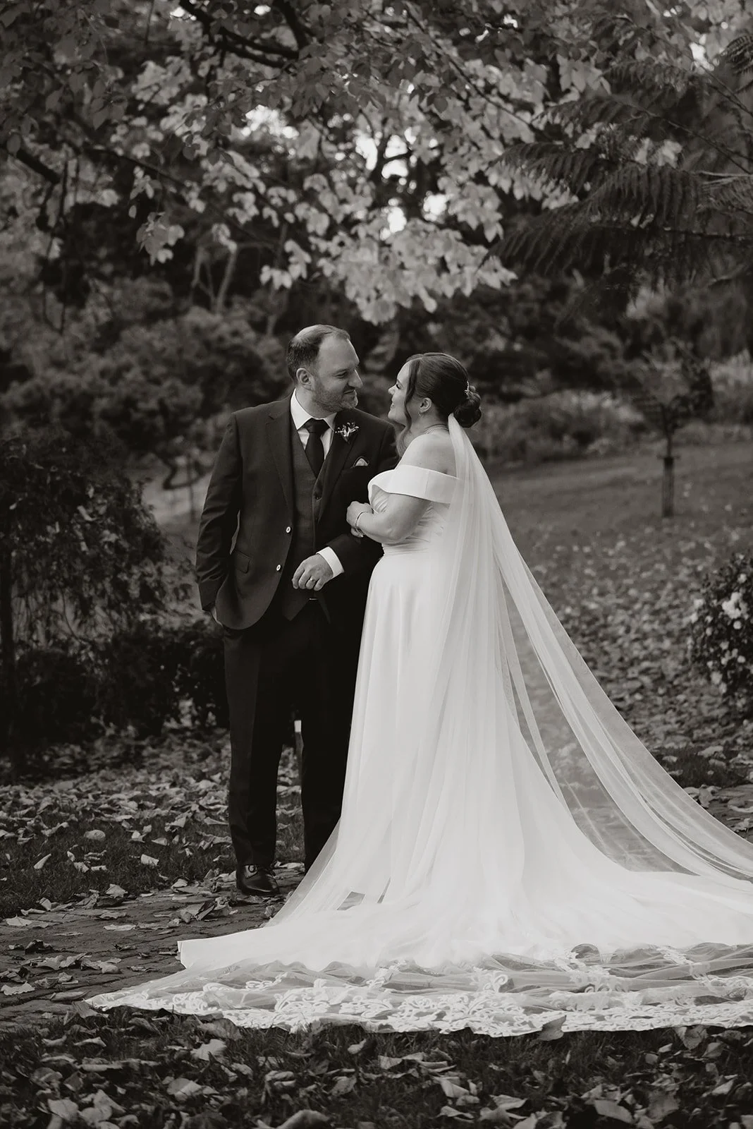 Bride and groom standing together in a garden during their wedding day, captured in Melbourne by Shadowfax Photography.