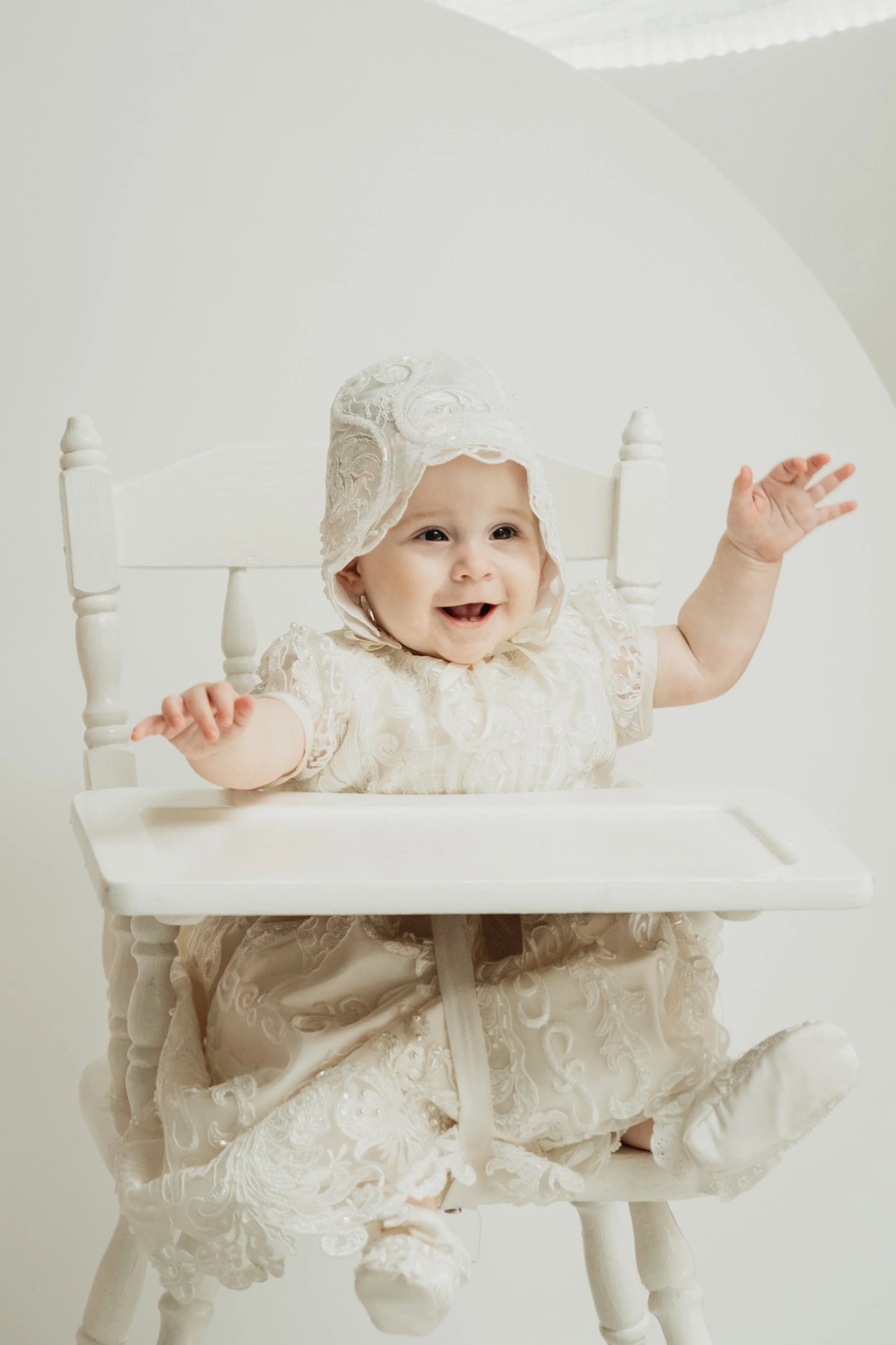 Baby dressed in traditional christening dress, photographed during a Melbourne baptism photography session Melbourne.
