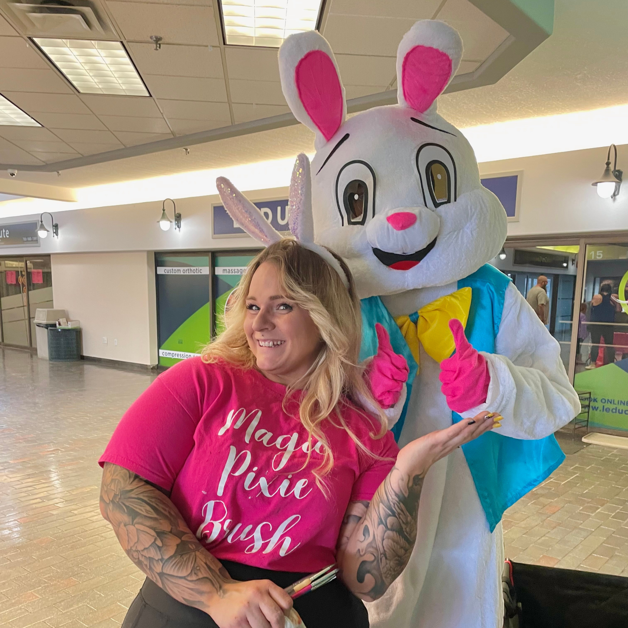 Easter bunny having fun with face painters at local Leduc event