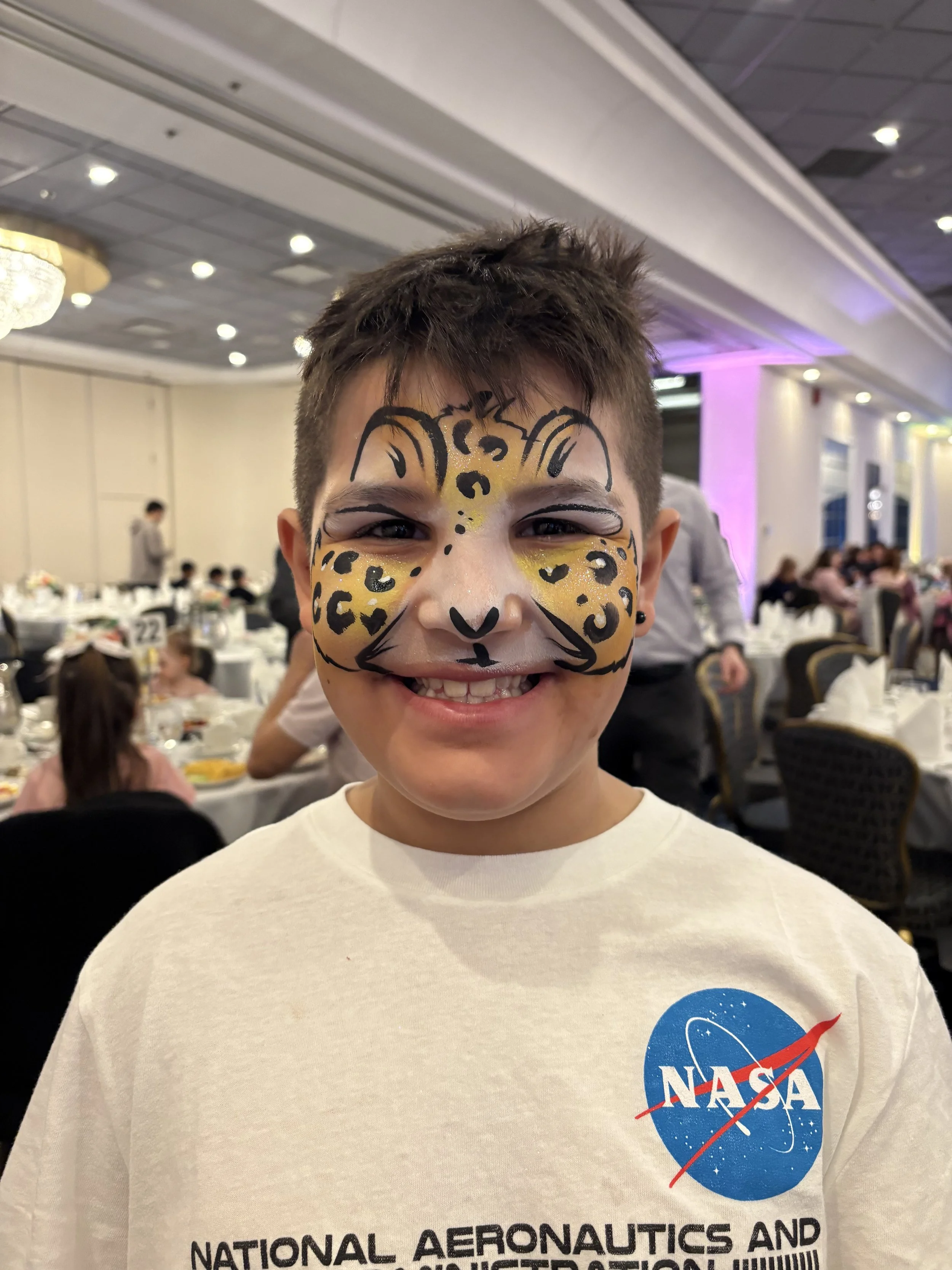 Happy children with professional face painting at a corporate event in Edmonton