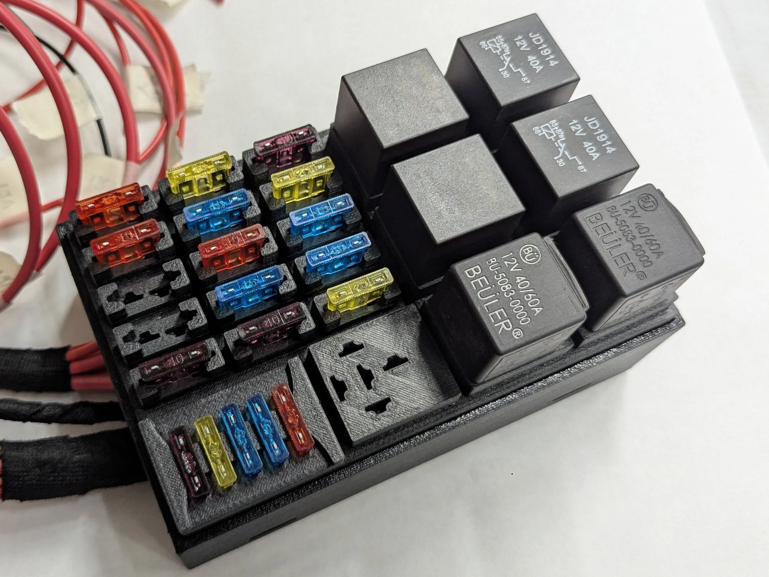 Custom engine bay fuse box for a 77 Corvette. Supporting up to 15 ATC fuses, 7 relays, and features a 5 slot spare fuse holder.