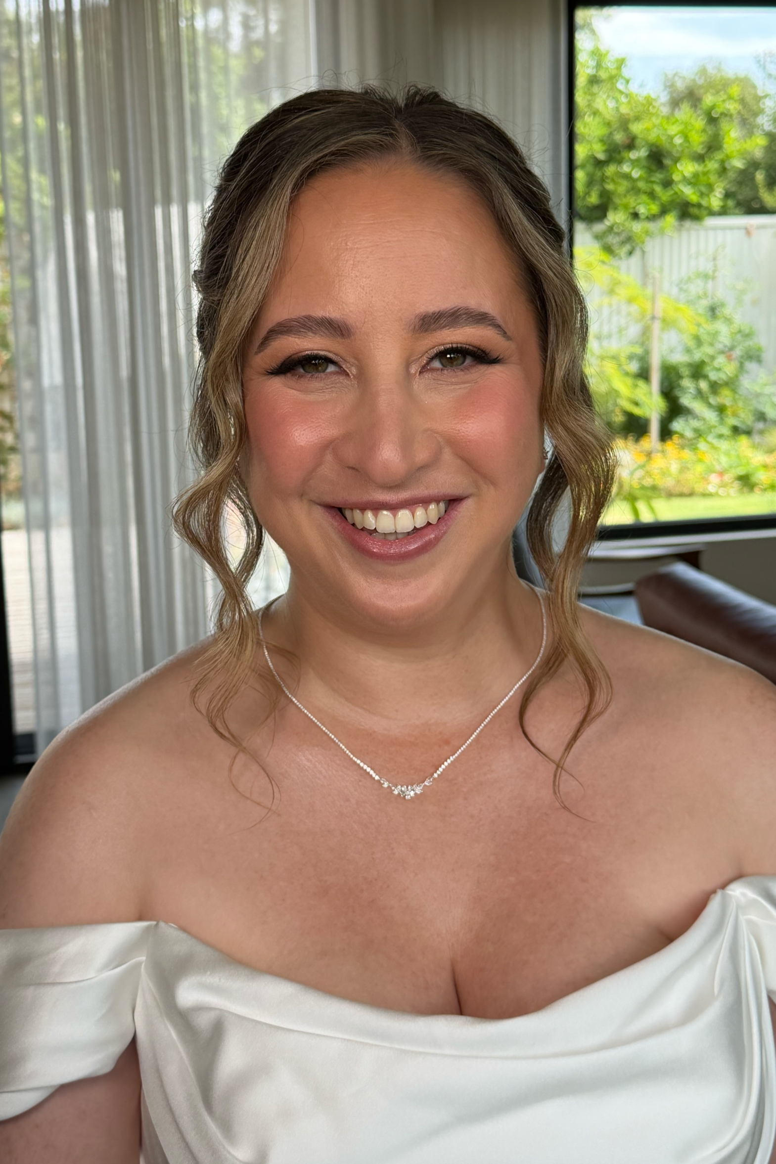 glowing bride makeup look pink cheeks fluffy lashes
