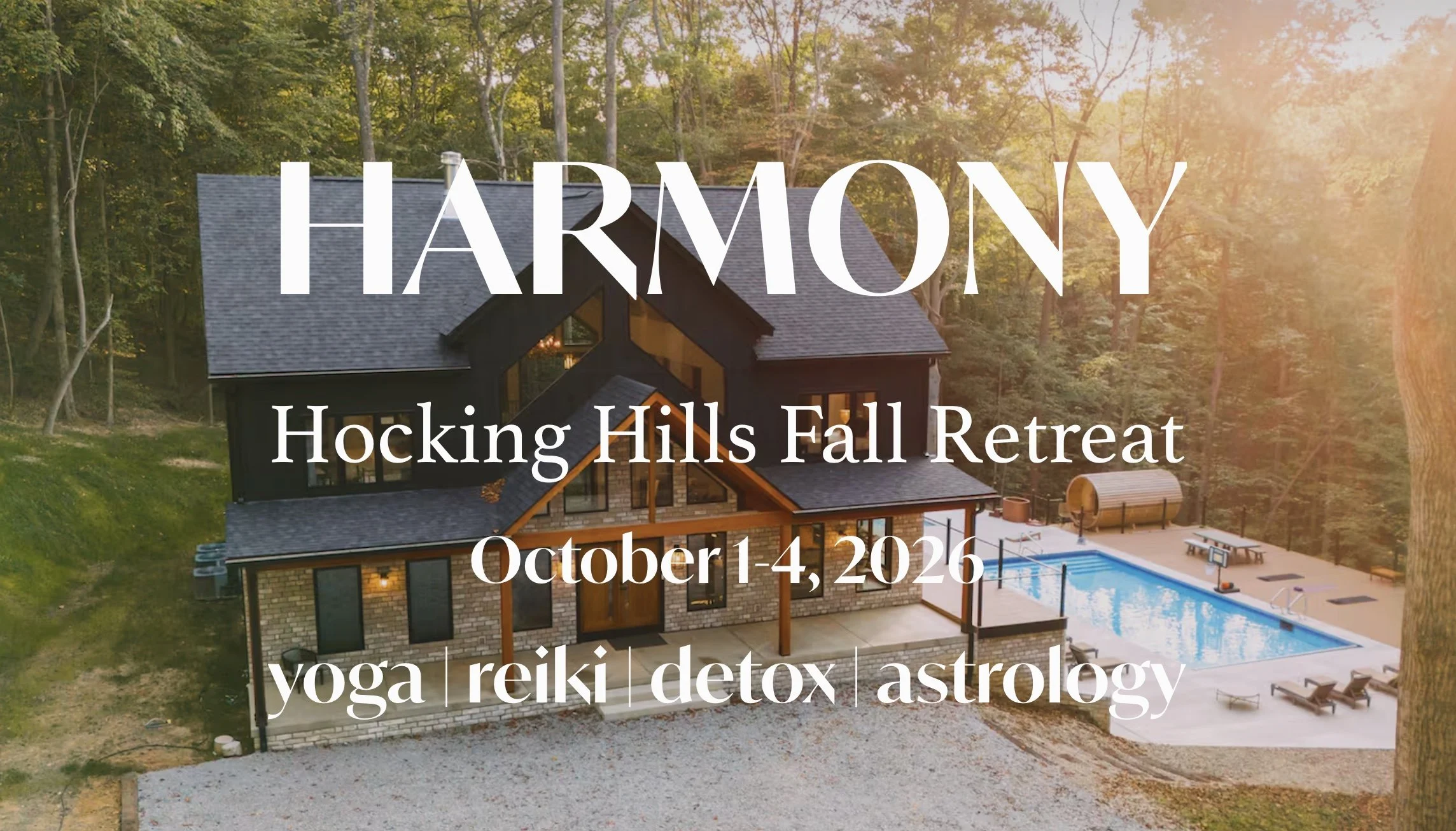 A large black house with a sloped roof, surrounded by trees, with a pool and outdoor seating area, and sunset lighting.