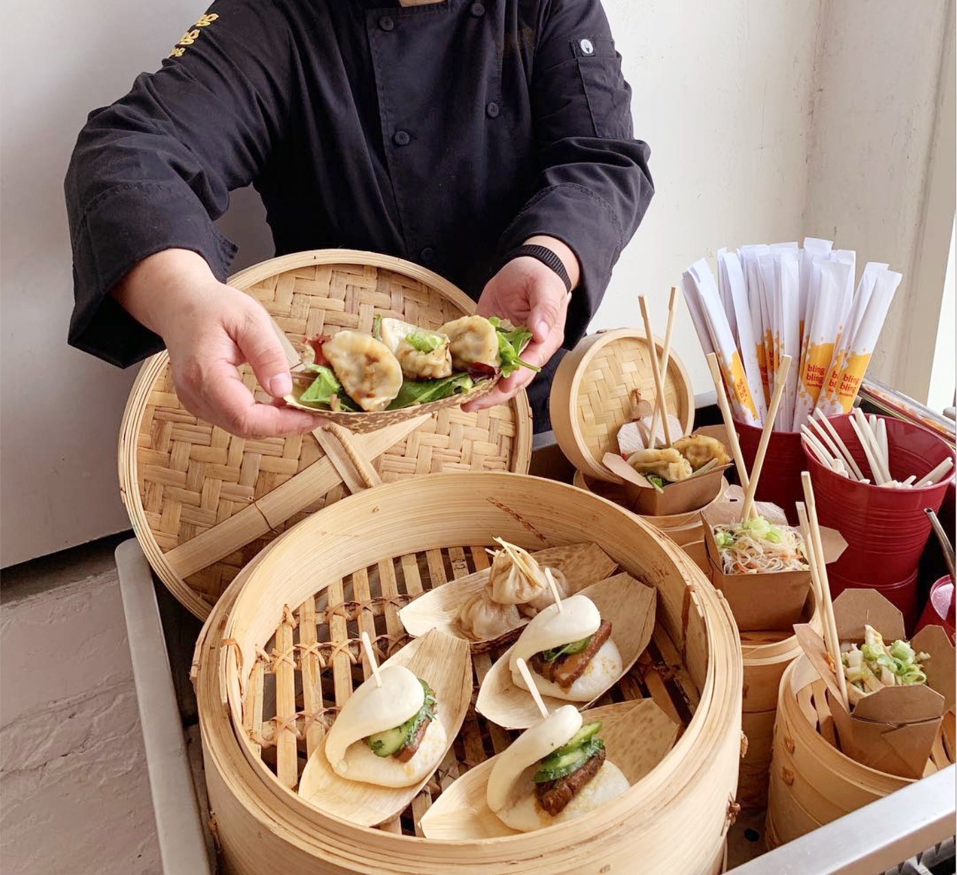 Dim Sum cart with bamboo steamers serving bao, rice noodles, and dumplings