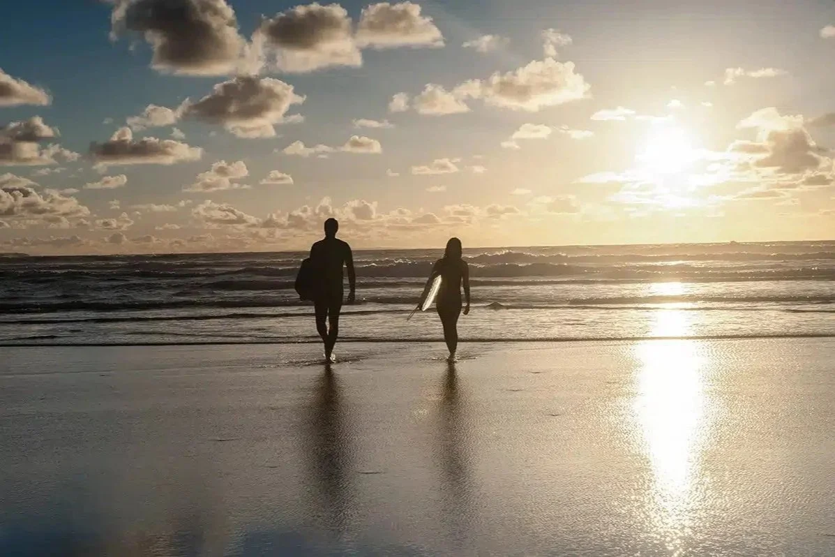 Couple surfing in Cornwall