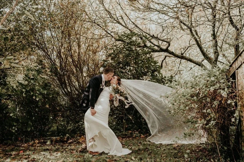 Wedding couple embracing in the woods