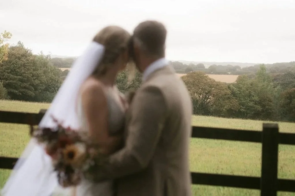 Wedding couple looking out over the fields