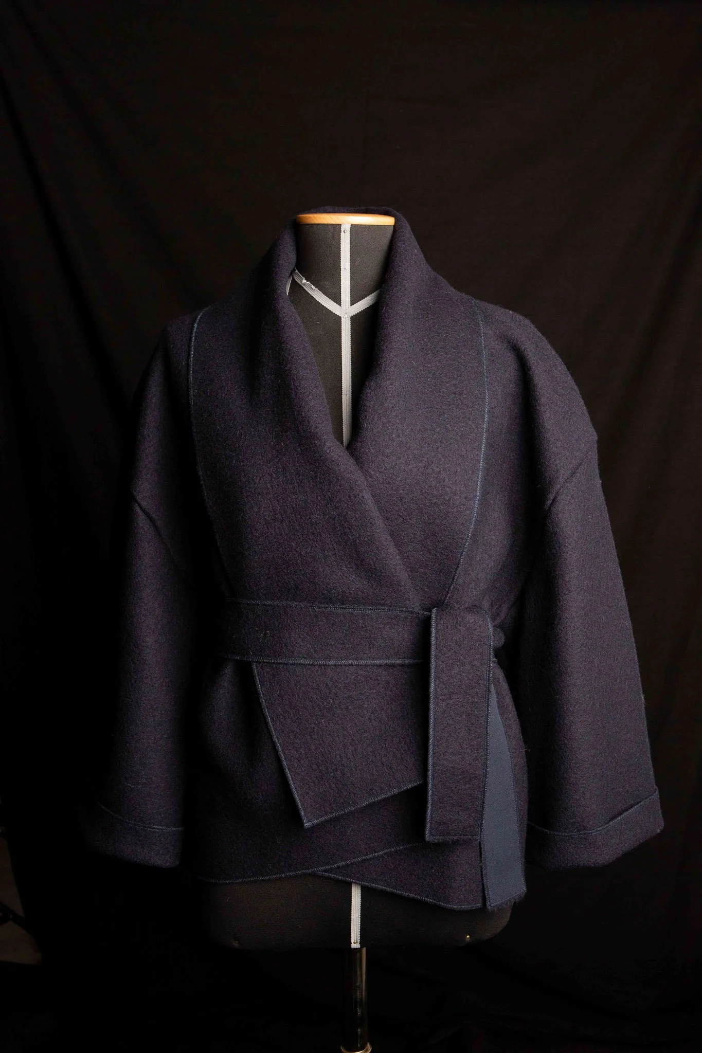 Kimono jacket crafted from Austrian boiled wool. 100% pure new wool. Detachable collar and waistbelt.