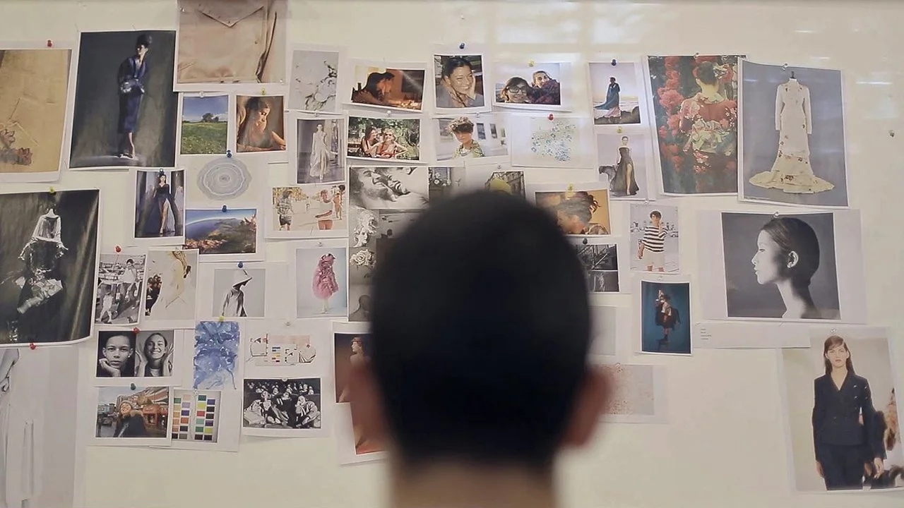 Daniele Orlandi inside his atelier looking at the moodboard and inspirations behind the collection.