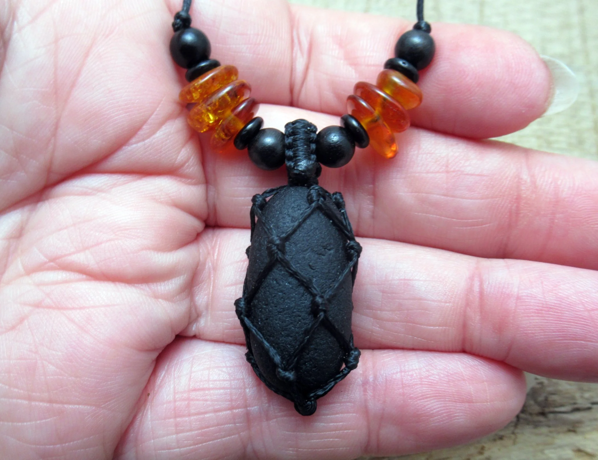 Pirate glass necklace with amber and wood beads, historic sea glass pendant