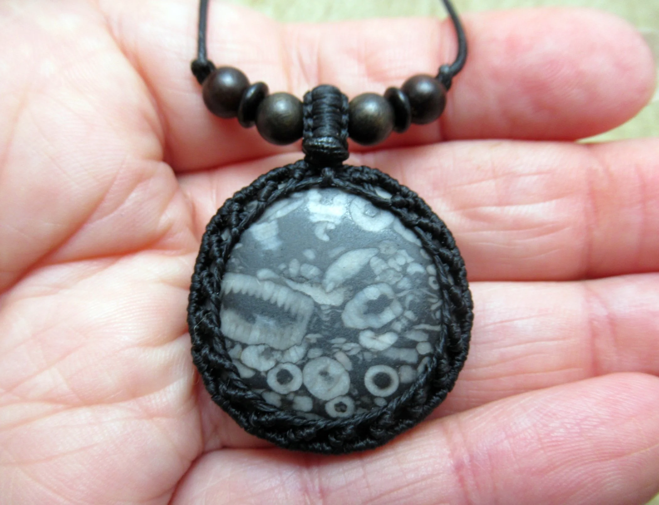 Lovely crinoid fossil macrame necklace, with mixed wood and coconut shell beads