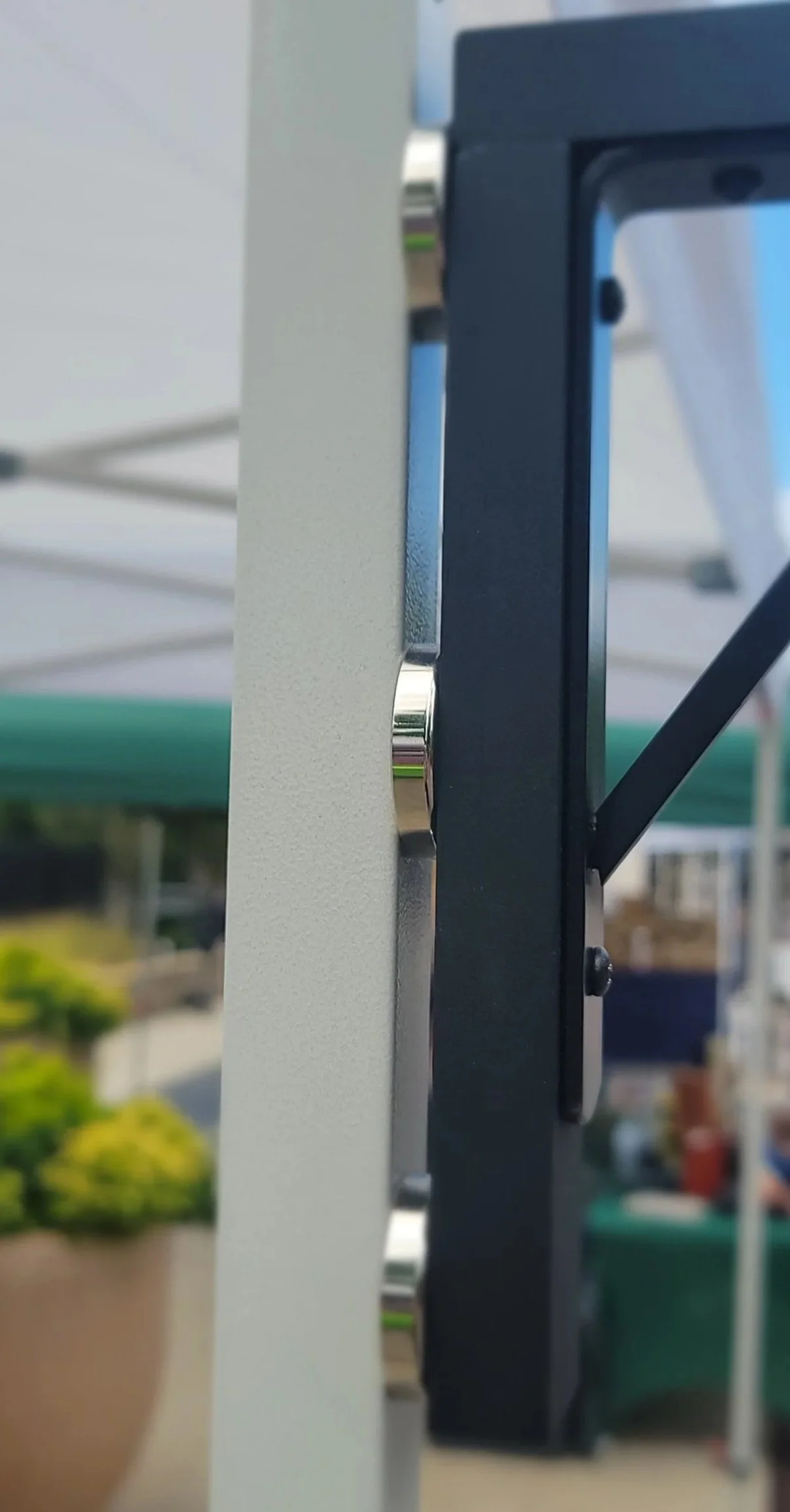 Magnets hold sign to canopy