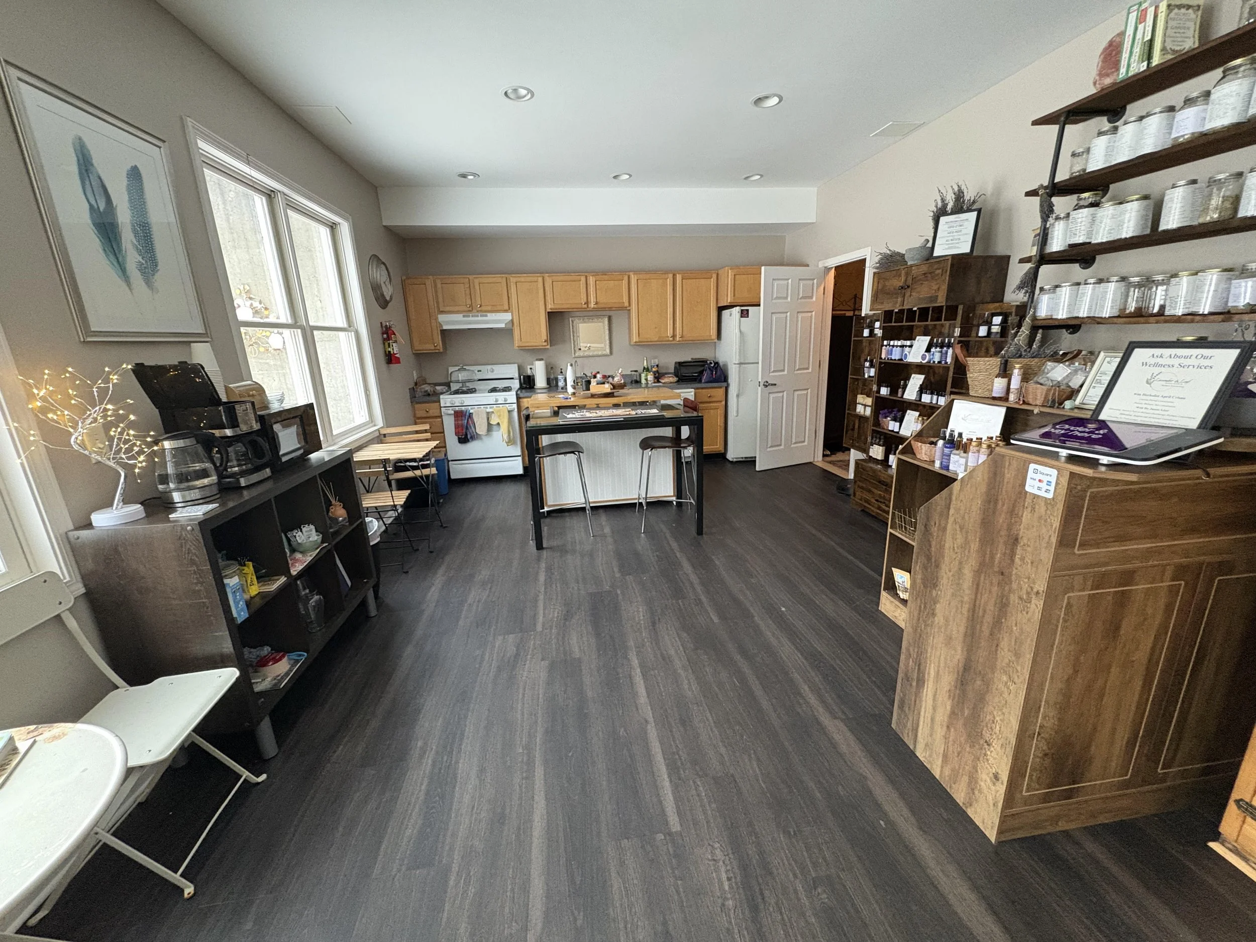 Image of kitchen with tea shelves to right and windows to left