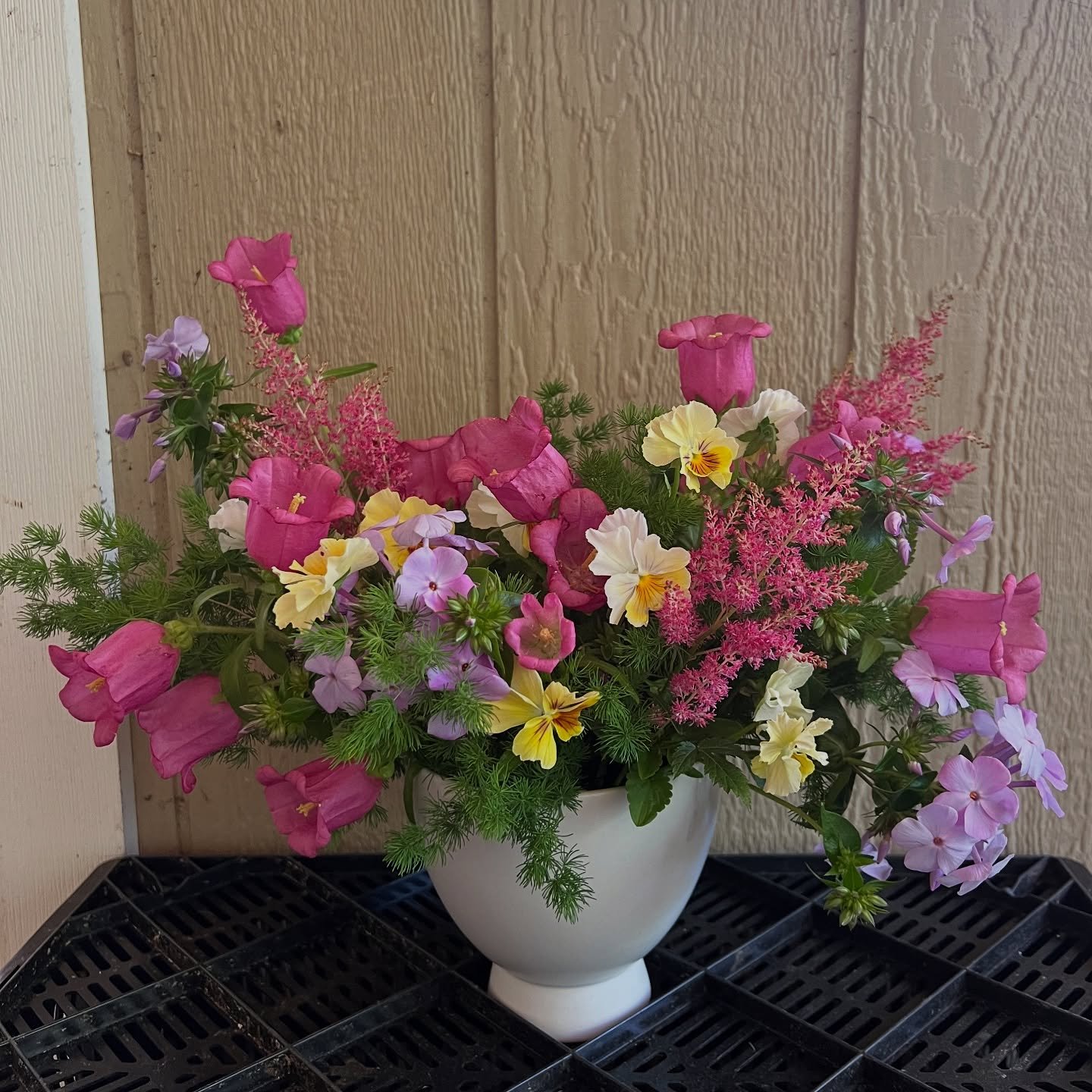 A last minute &ldquo;garden party&rdquo; style arrangement featuring campanula, phlox, pansies, astilbe and some leftover wholesale Ming fern.