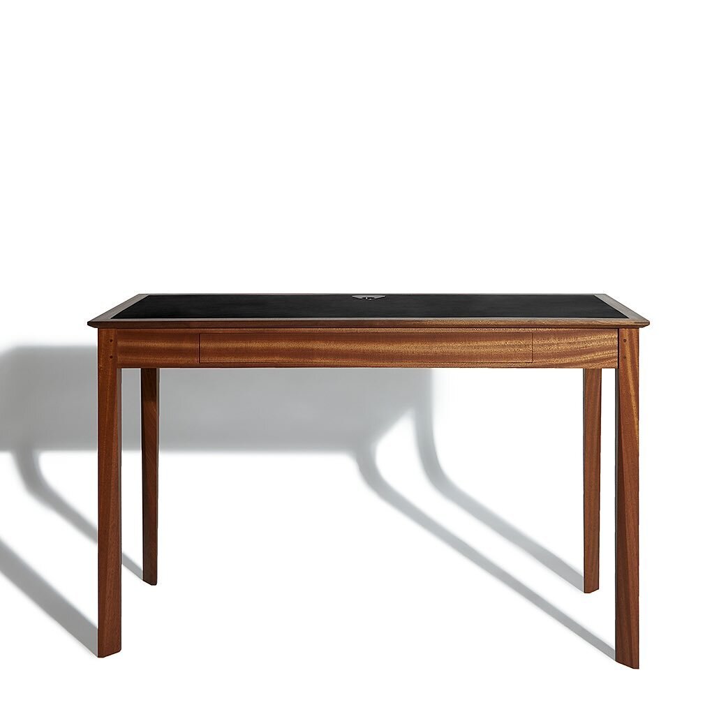 A beautiful writing desk in Sapele, Black Full Grain Leather and Solid Brass.
After over 10 years of fabricating custom furniture, a well executed piece always makes us excited. 
Here we&rsquo;ve got all the details&mdash;pinned joints, splined mitre