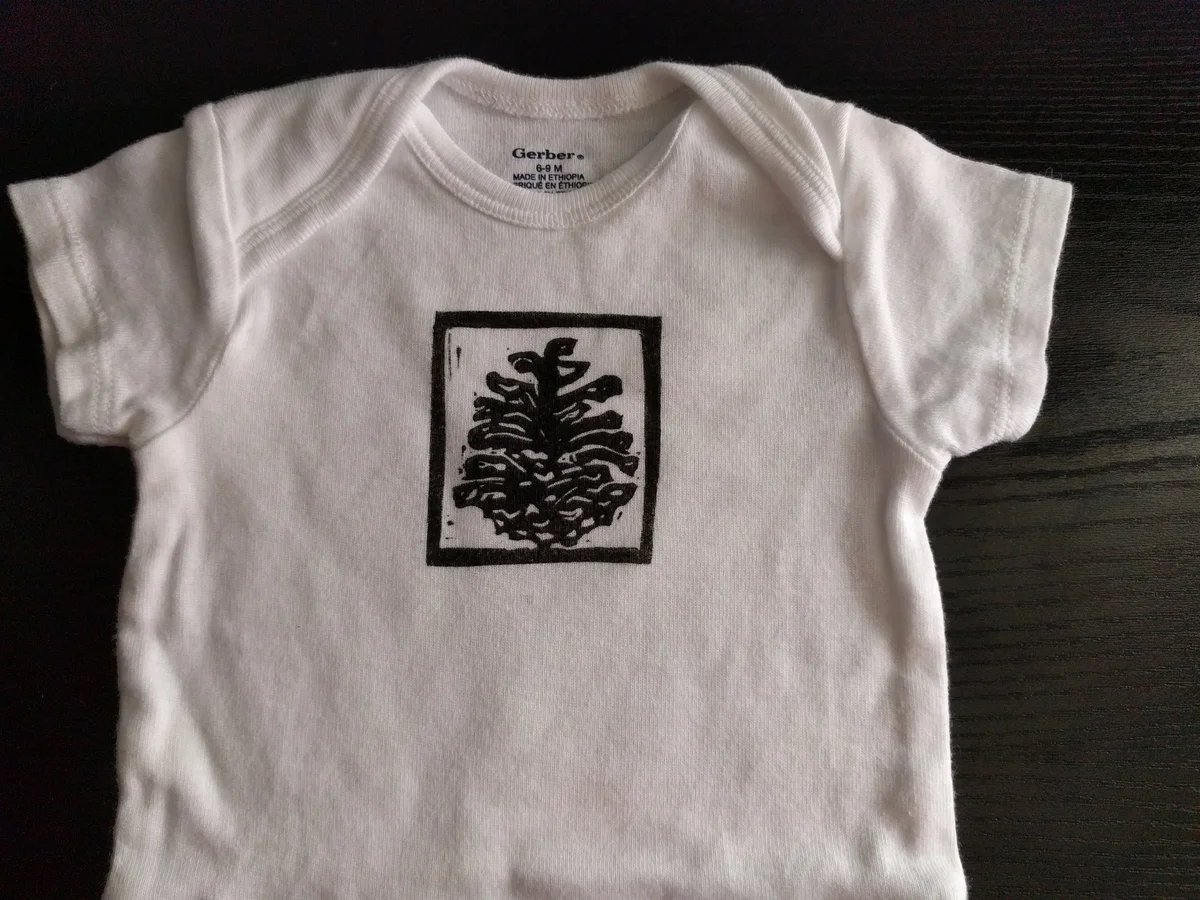 Yael_onesie_pine_cone.jpeg