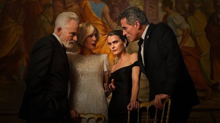 Two men in tuxedos stand next to two women in gowns as they all lean over a chair