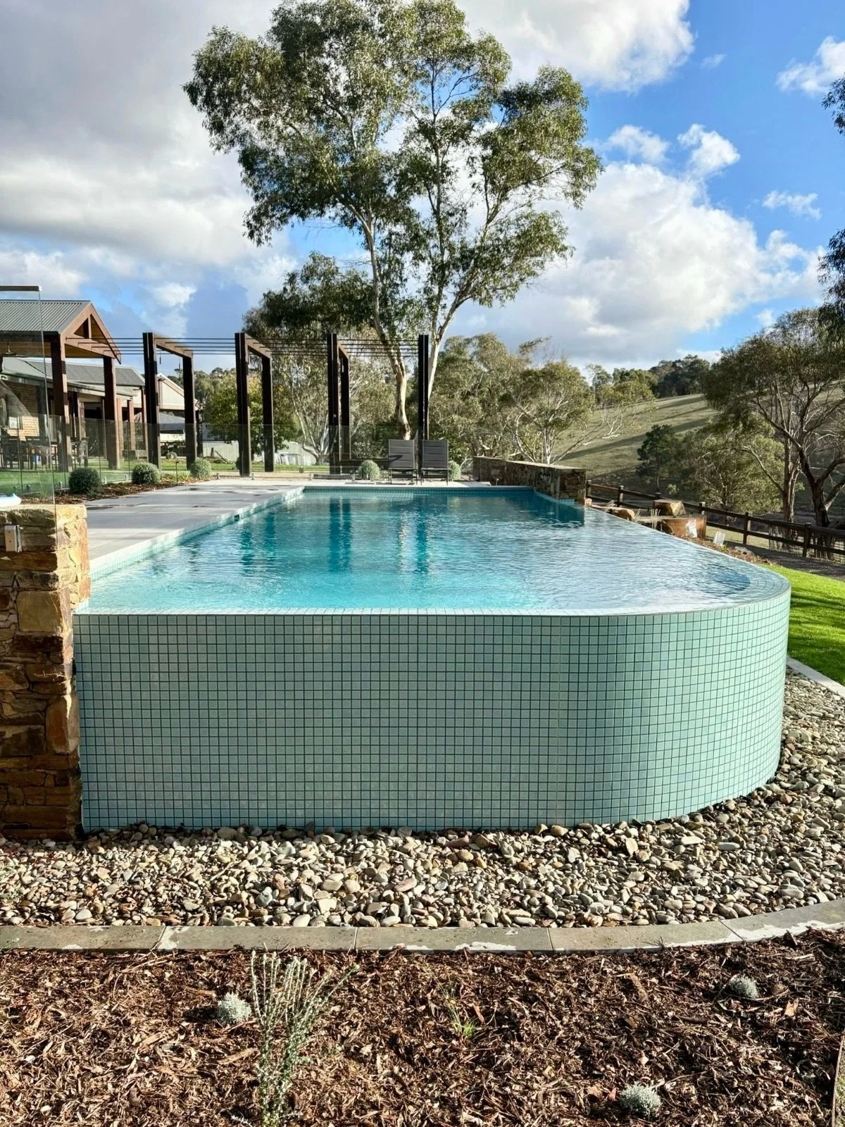 Curved wet edge pools might look simple, but they take real precision to get right.

Along a radius like this, the structure, levels and waterline tiles all need to align perfectly so the water reads as one calm line.

At Kangaroo Ground, that curve 