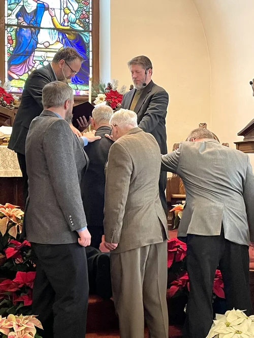 Our pastors and elders praying with the laying on of hands