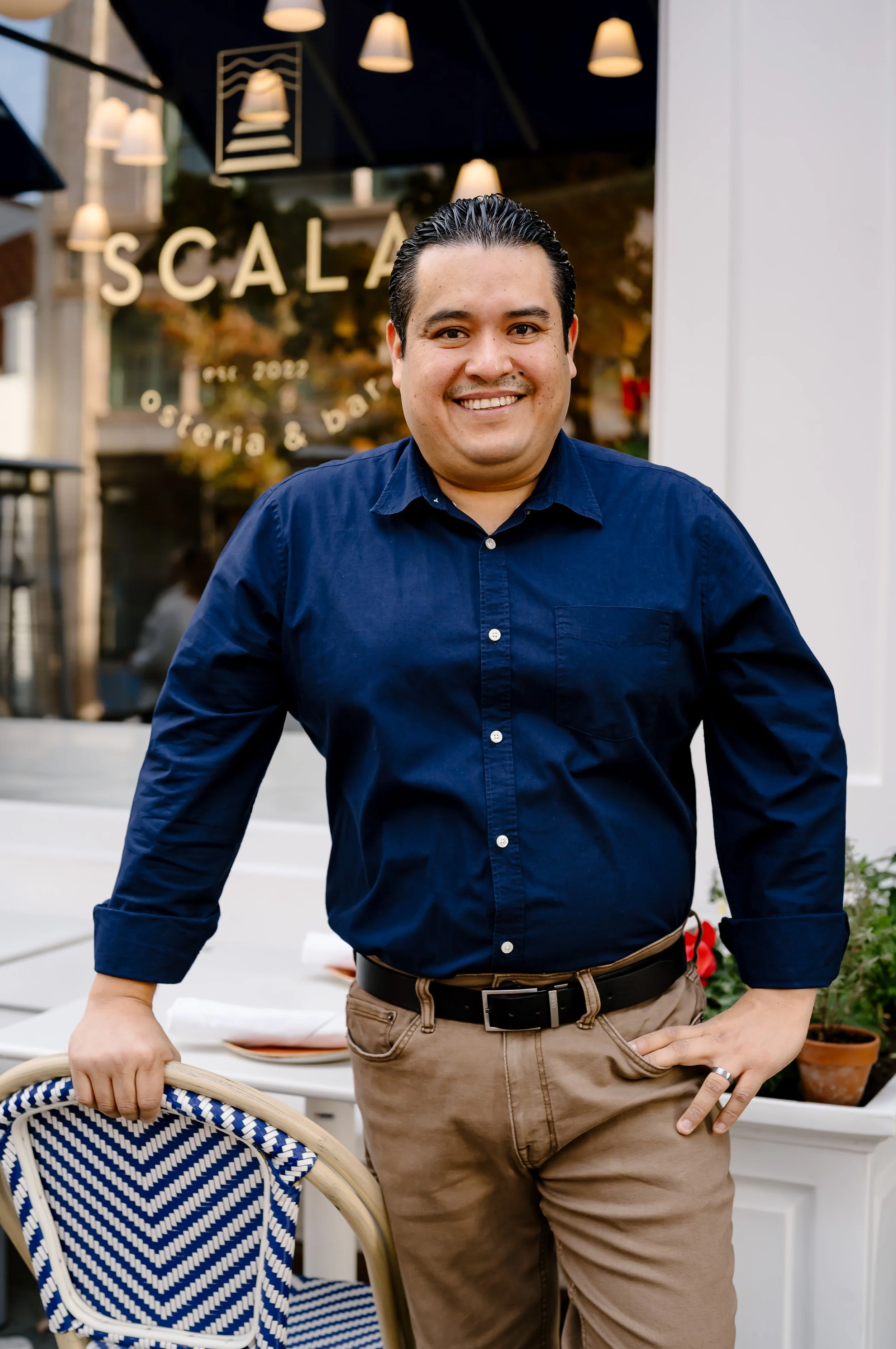 Smiling General Manager standing outside Scala Osteria restaurant
