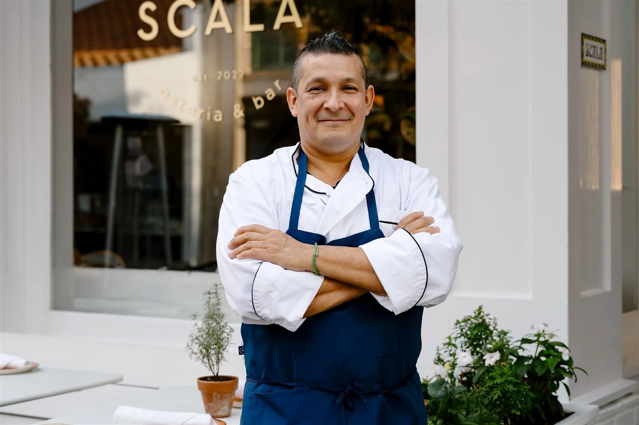 Executive Chef in chef whites standing outside Scala Osteria on First Street in Napa