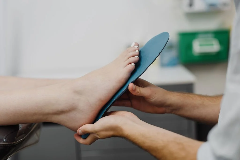 Sports Podiatrist fitting a custom-made orthotic