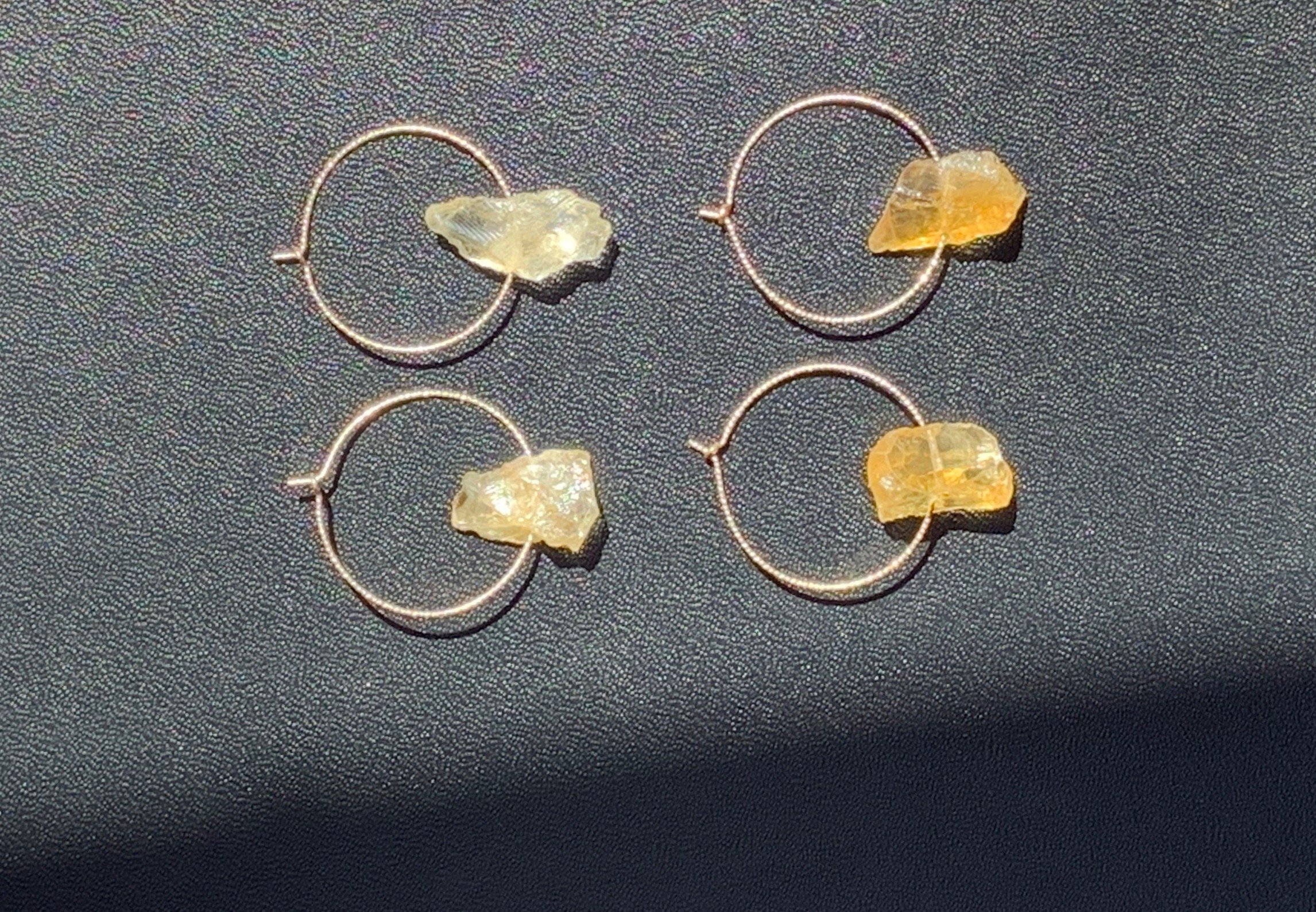 AUGUST Earrings Top View Black Background