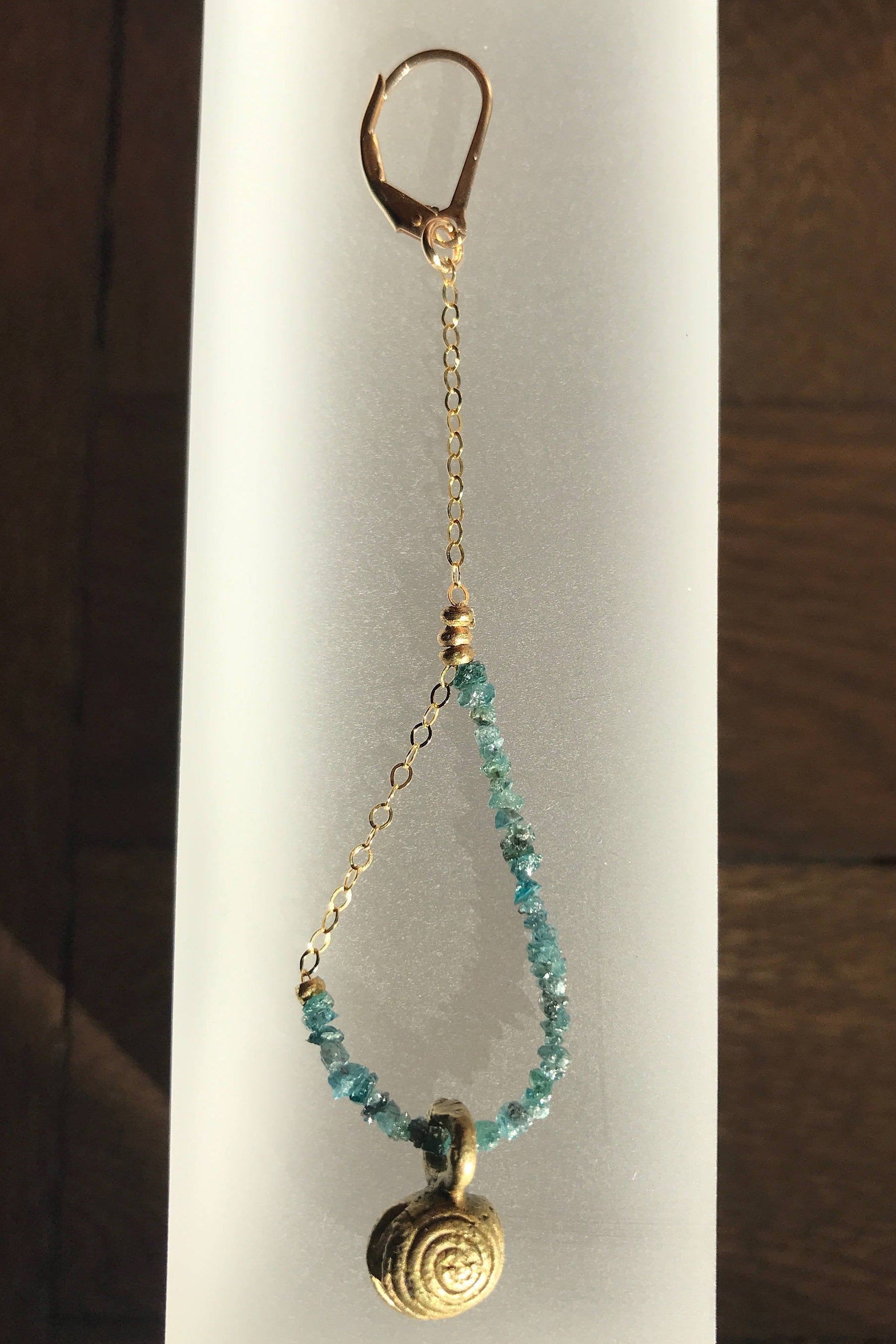 EPIPHANY Blue Diamonds Asymmetrical Earring Set Hanging On Display