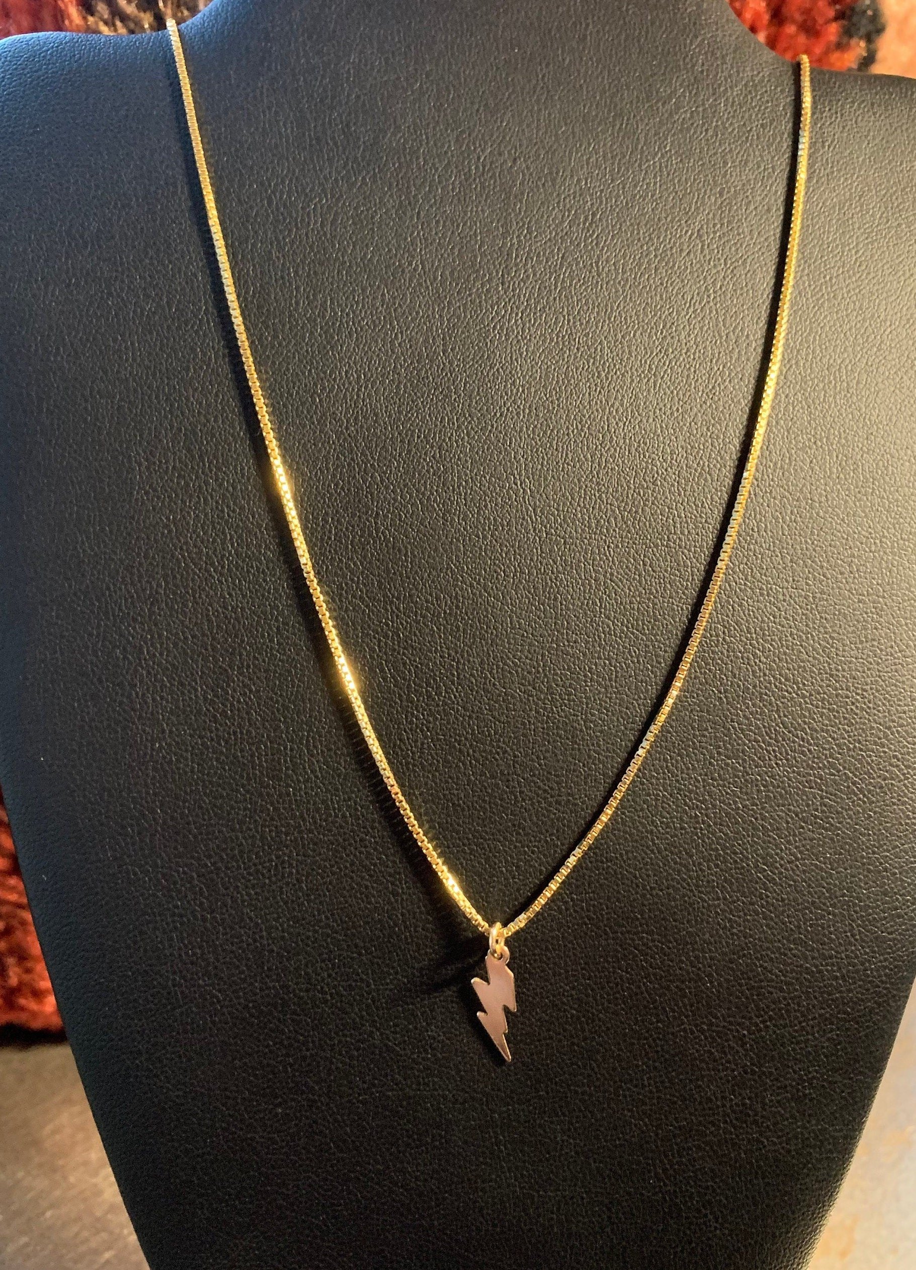 BOWIE BOLT Charm Necklace Hanging On Display