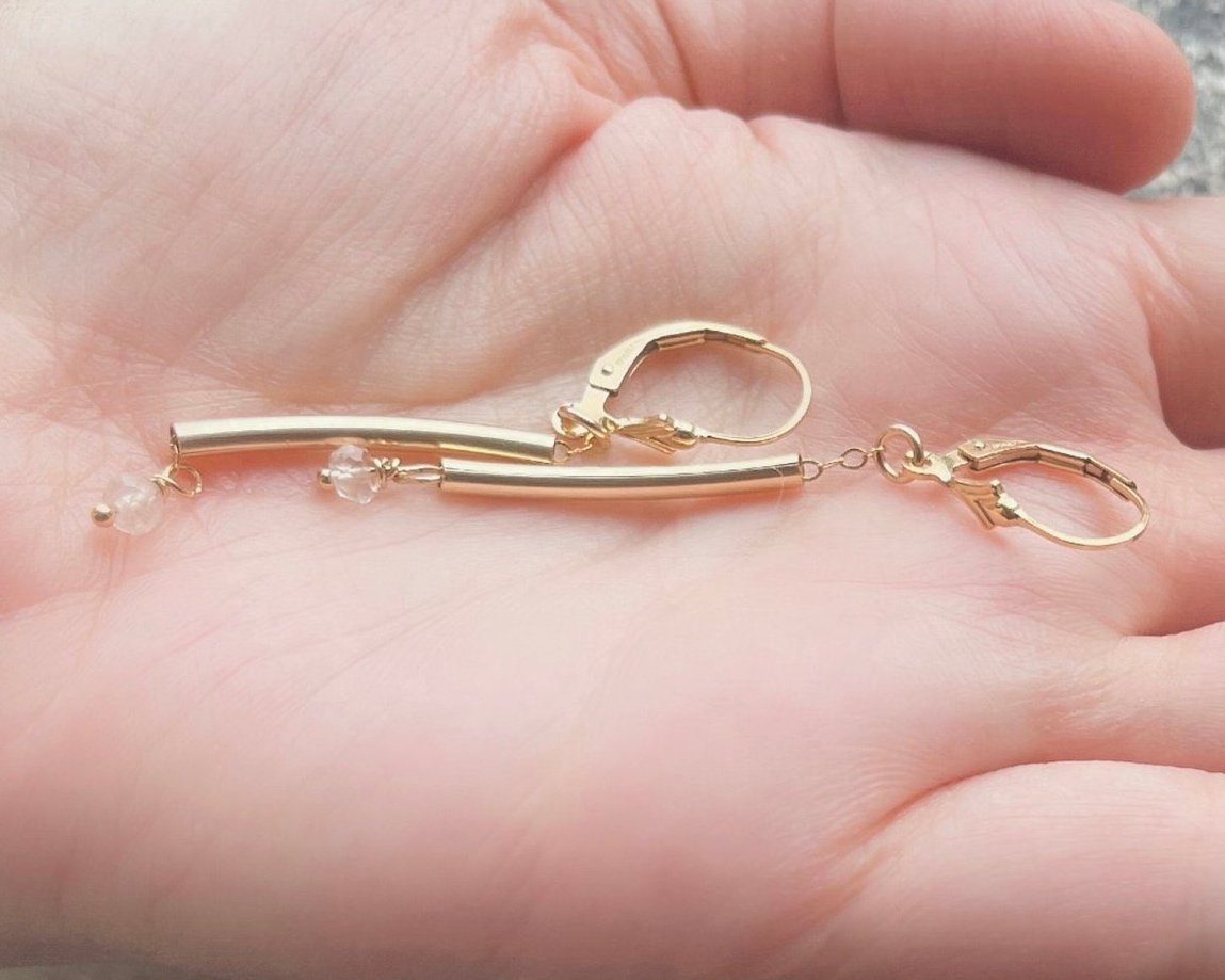AXEL Earrings Holding In Hand