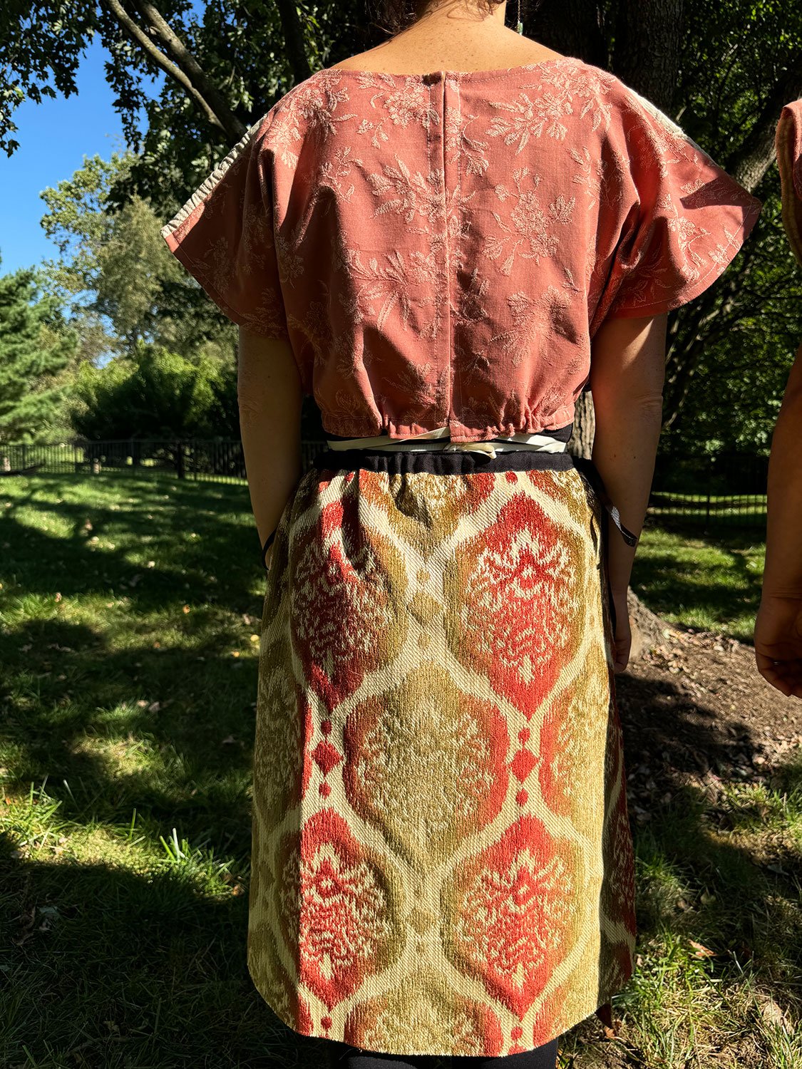 Frida Capelet and Piper skirts/dress/cape worn on model back view