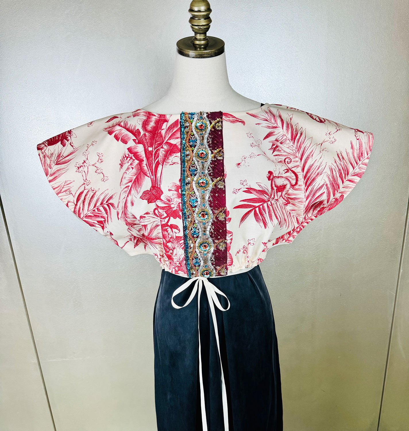 Frida Capelet shown with antique beaded repurposed embellished Sari fragment and gros grain ribbon tie on mannequin