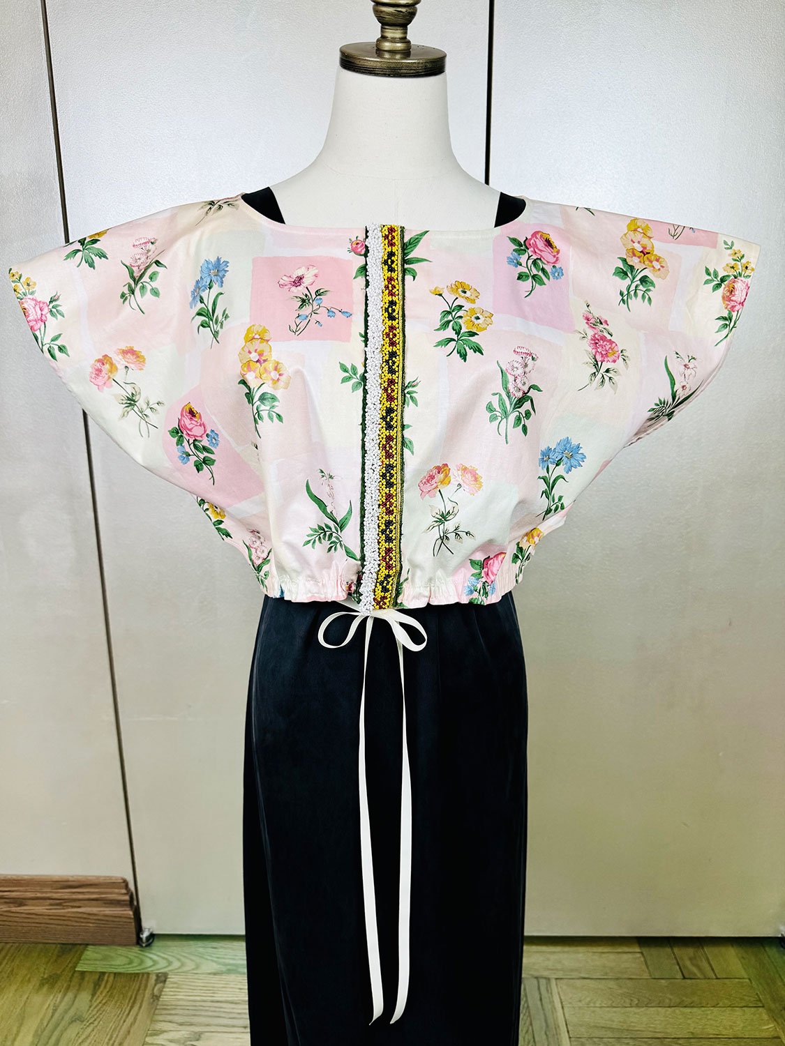 Frida capelet pink coated chintz print and beaded tribal fragment adornment on mannequin close up