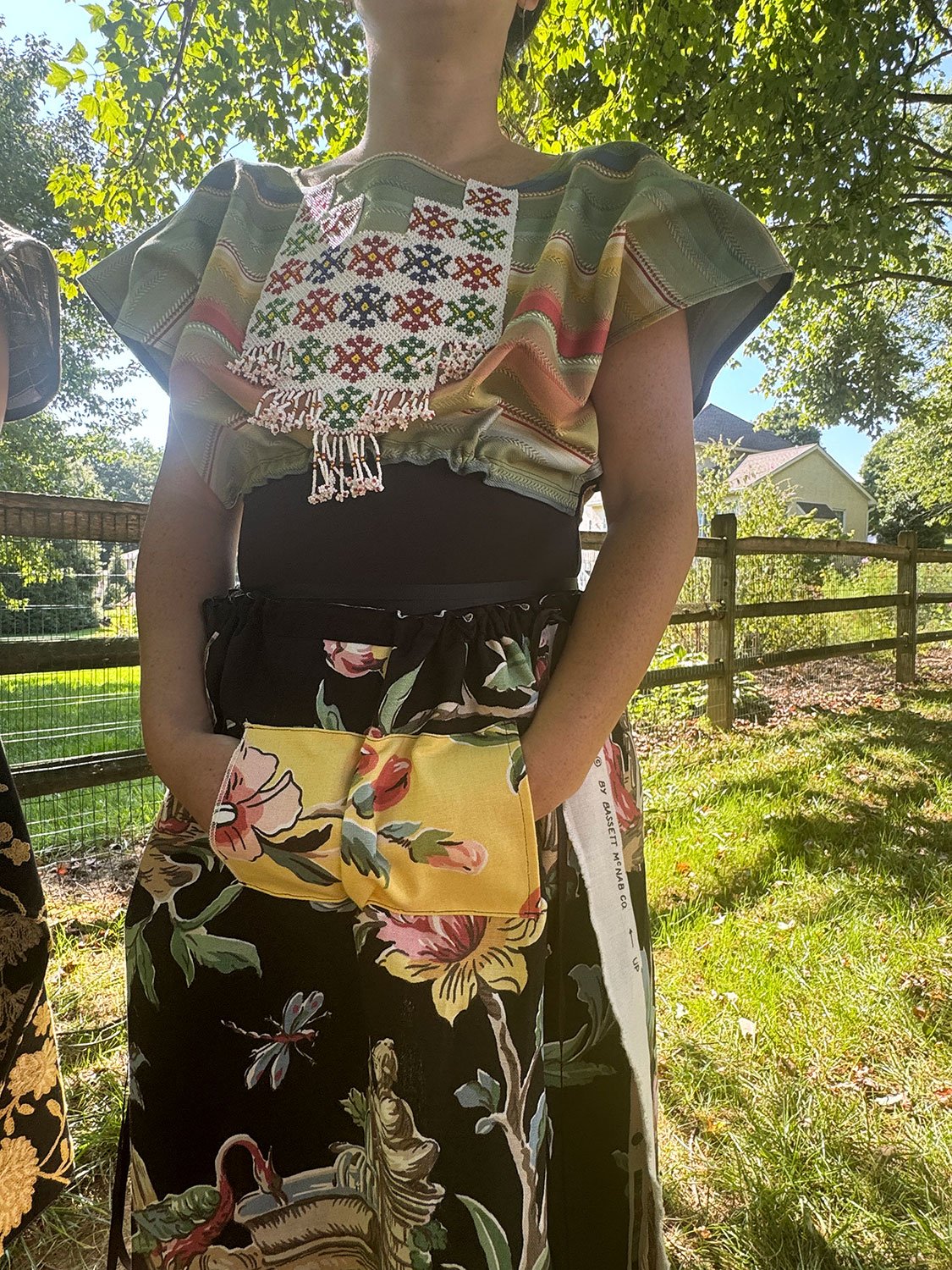 Frida Capelet with beaded antique tribal panel (close up) and Piper skirt hands in hoodie pocket on mode close upl