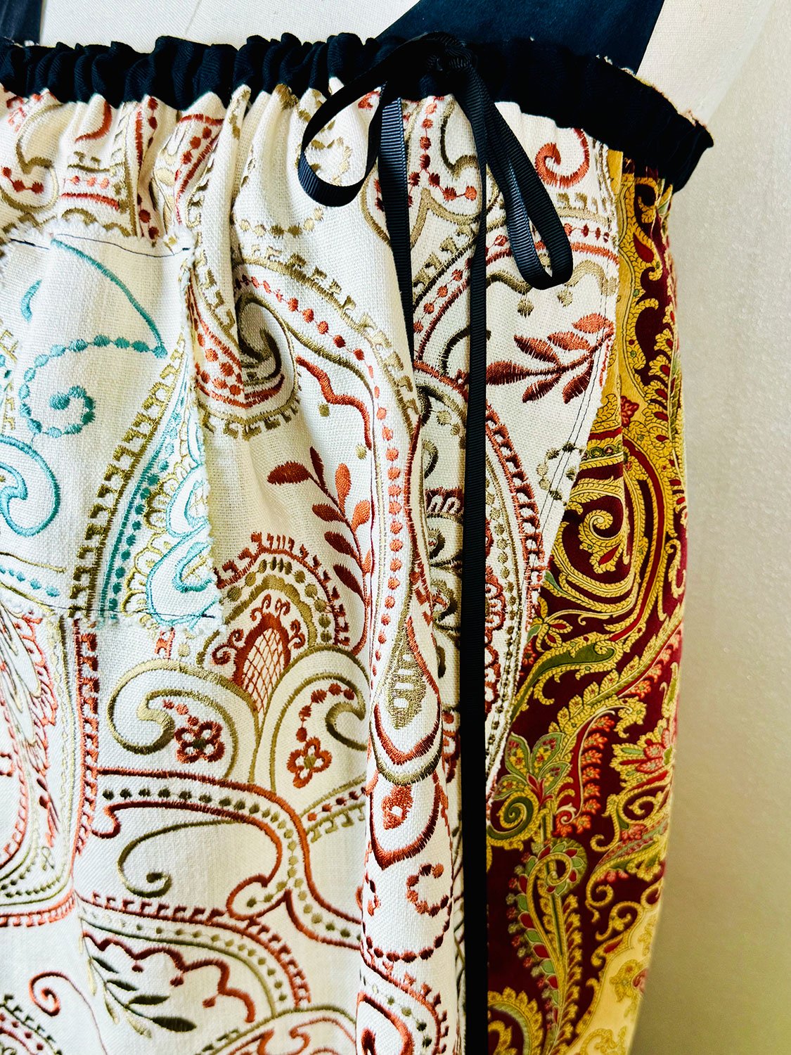 Piper skirt on mannequin shown as strapless dress front view with hoodie pocket & bow detail