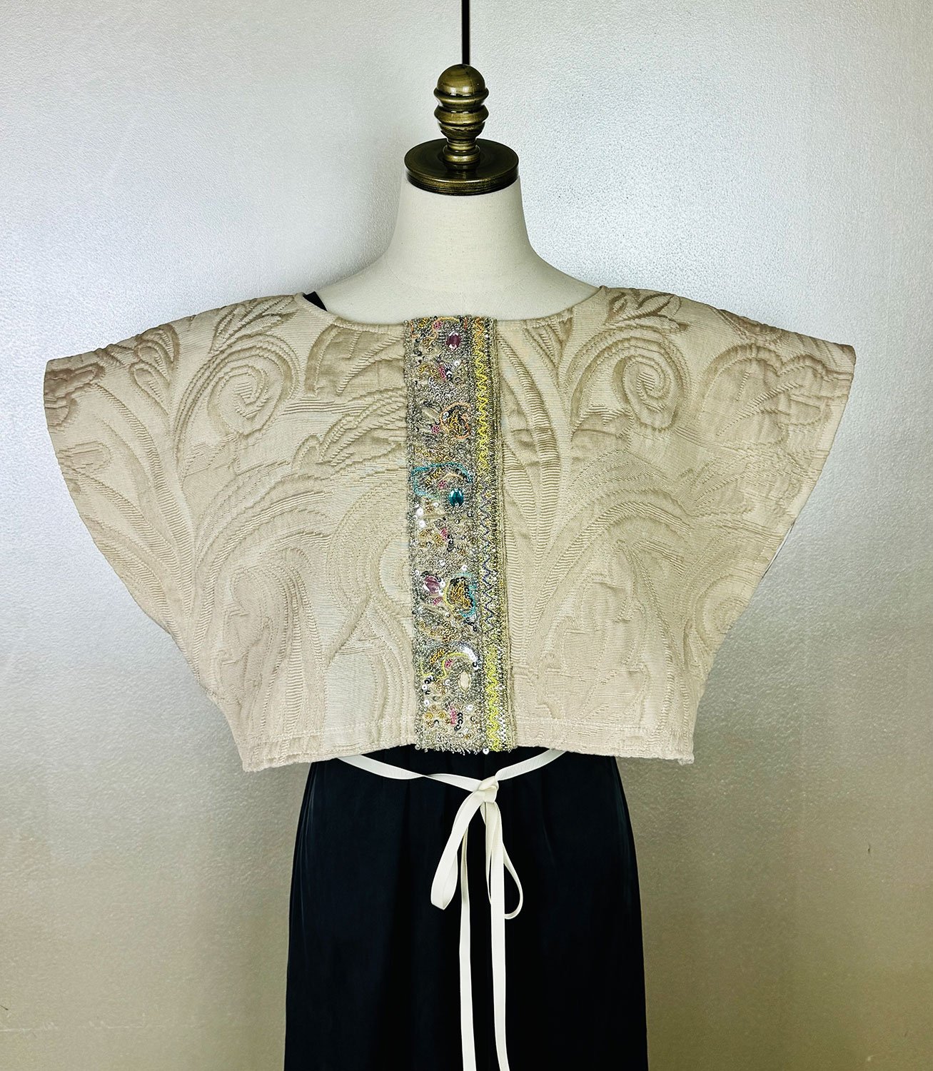 Frida Capelet with antique Sari fragment panels worn on front of mannequin loose with gros grain ribbon bow tie