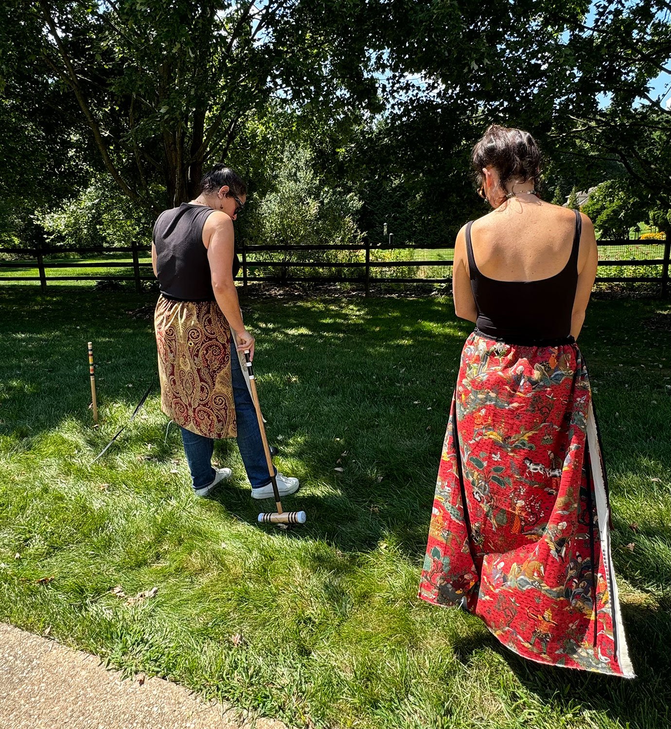 Piper overskirts worn over denim trousers on models back view