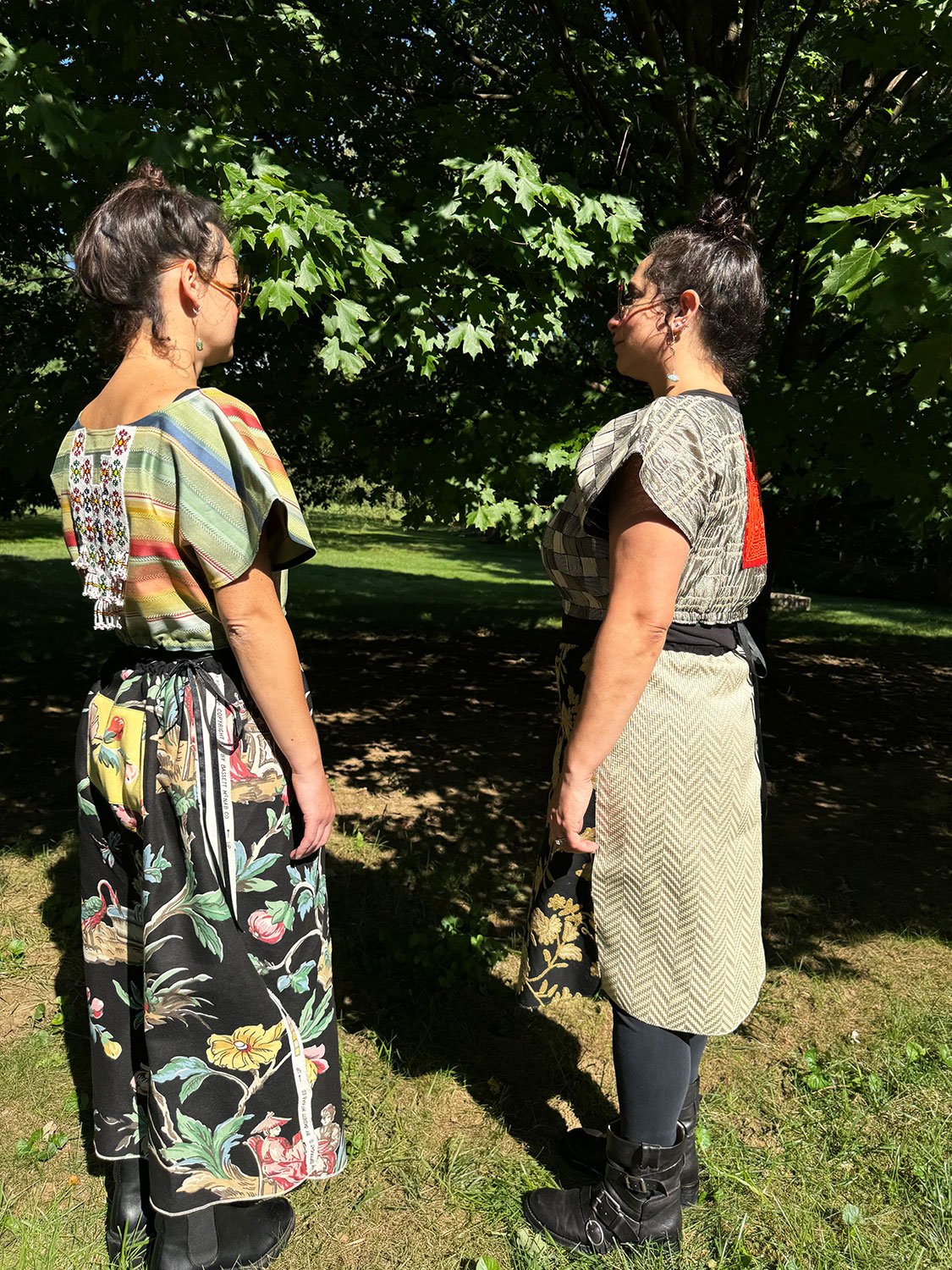 Frida Capelets with beaded and embroidered antique tribal panels and Piper skirts/dresses/capes on models standing facing one another worn reversed