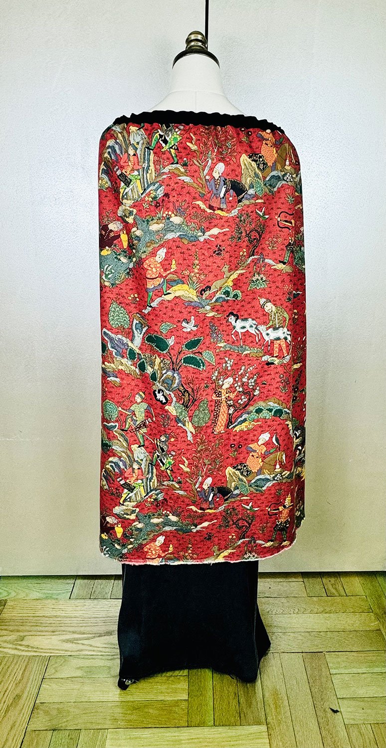 Piper overskirt on mannequin shown as cape on back