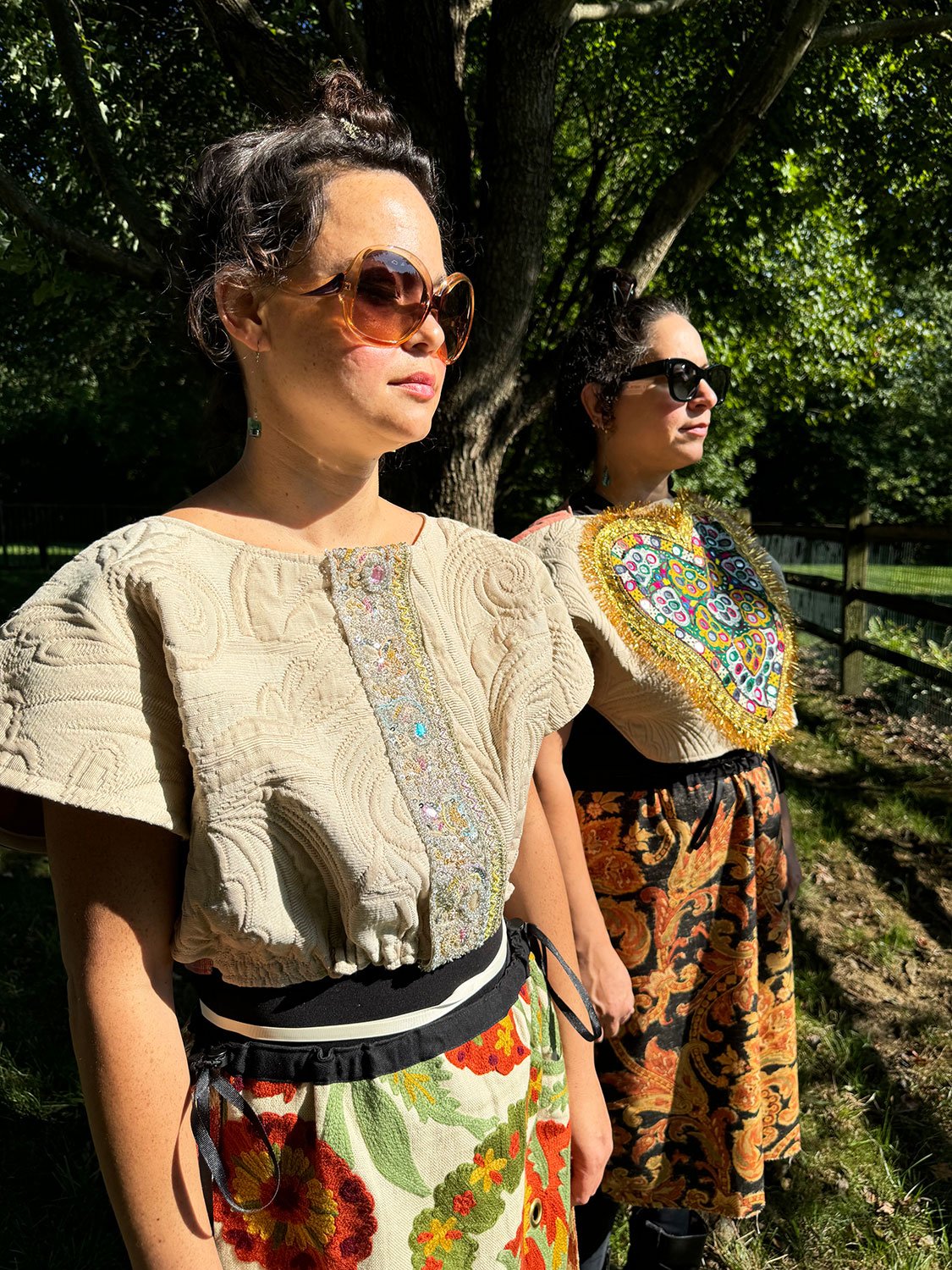 Frida Capelet with antique Sari fragment panel and Piper skirts/dress/cape worn on models side view