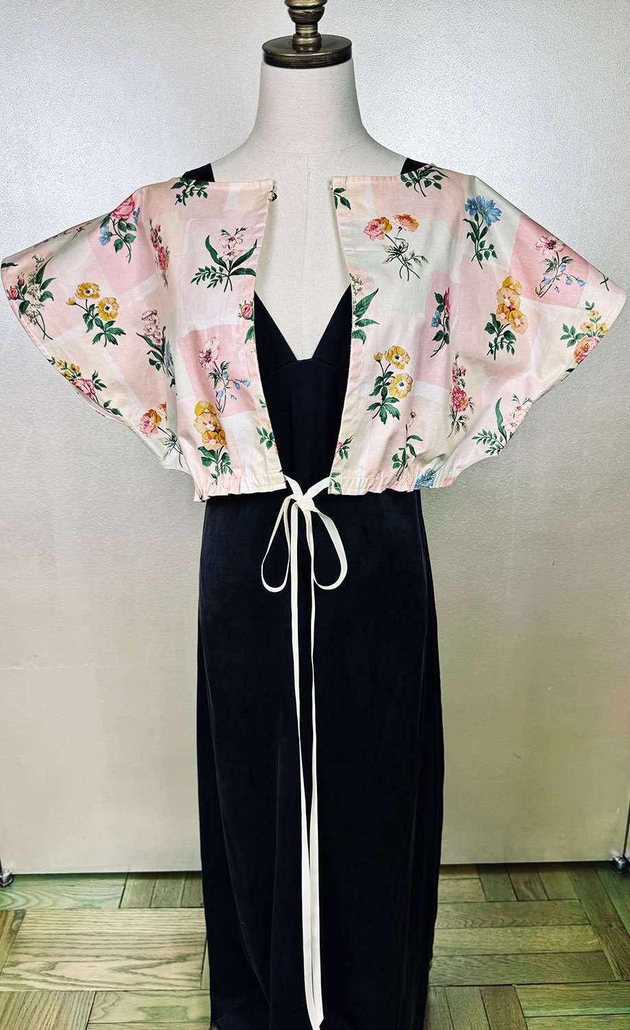 Frida Capelet pink coated chintz print worn open on mannequin close up
