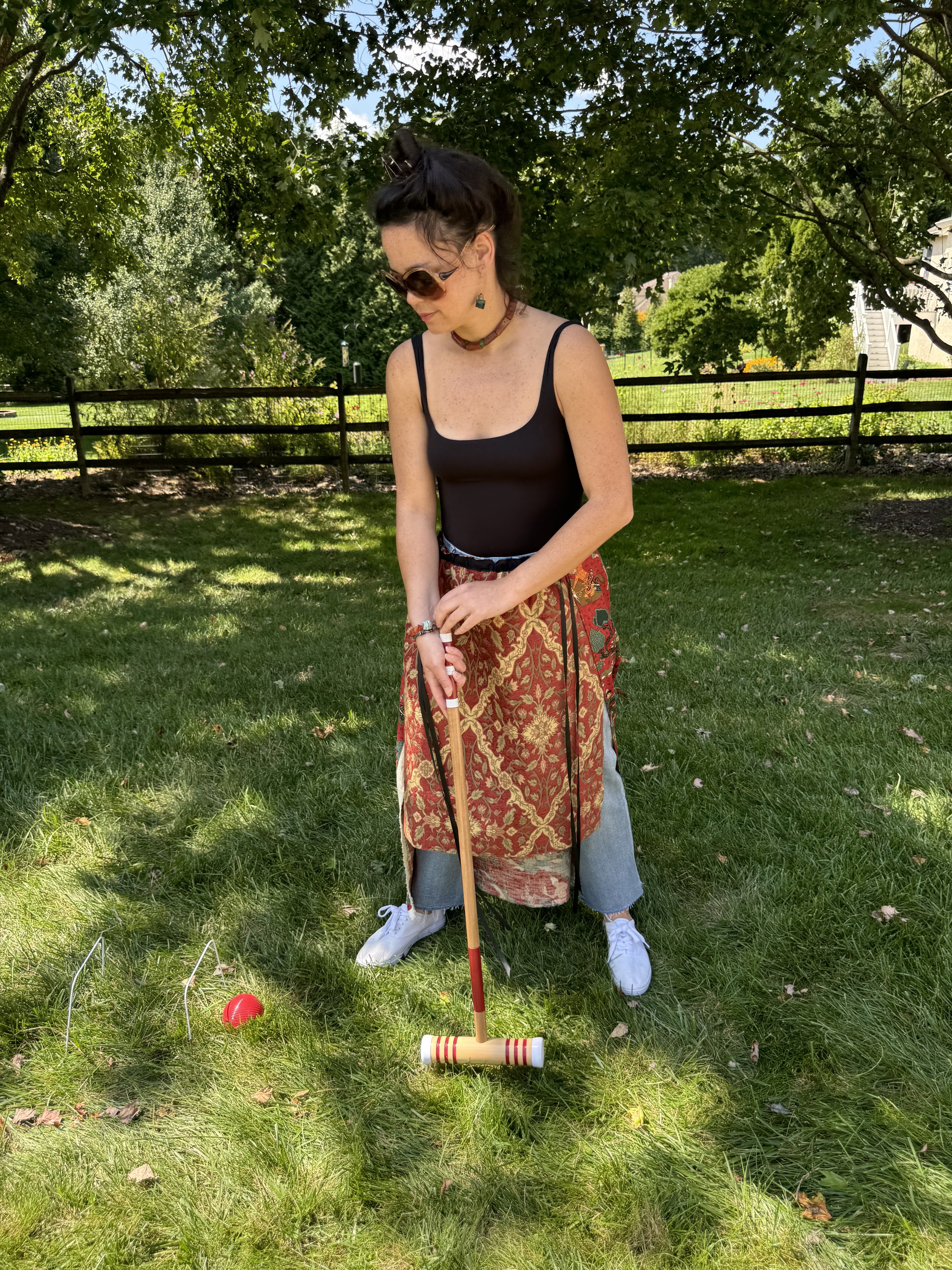 Simone bauxite and turquoise necklace on model playing croquet in Piper Over-Skirt