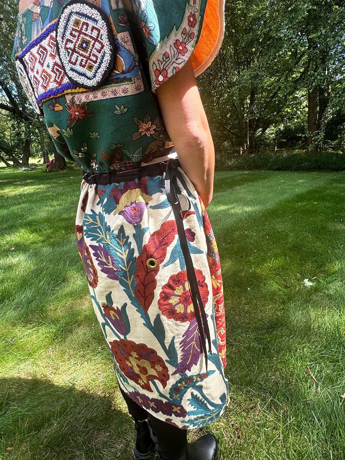 Frida Capelet with beaded antique tribal panel and Piper skirt/cape/dress on models side view close