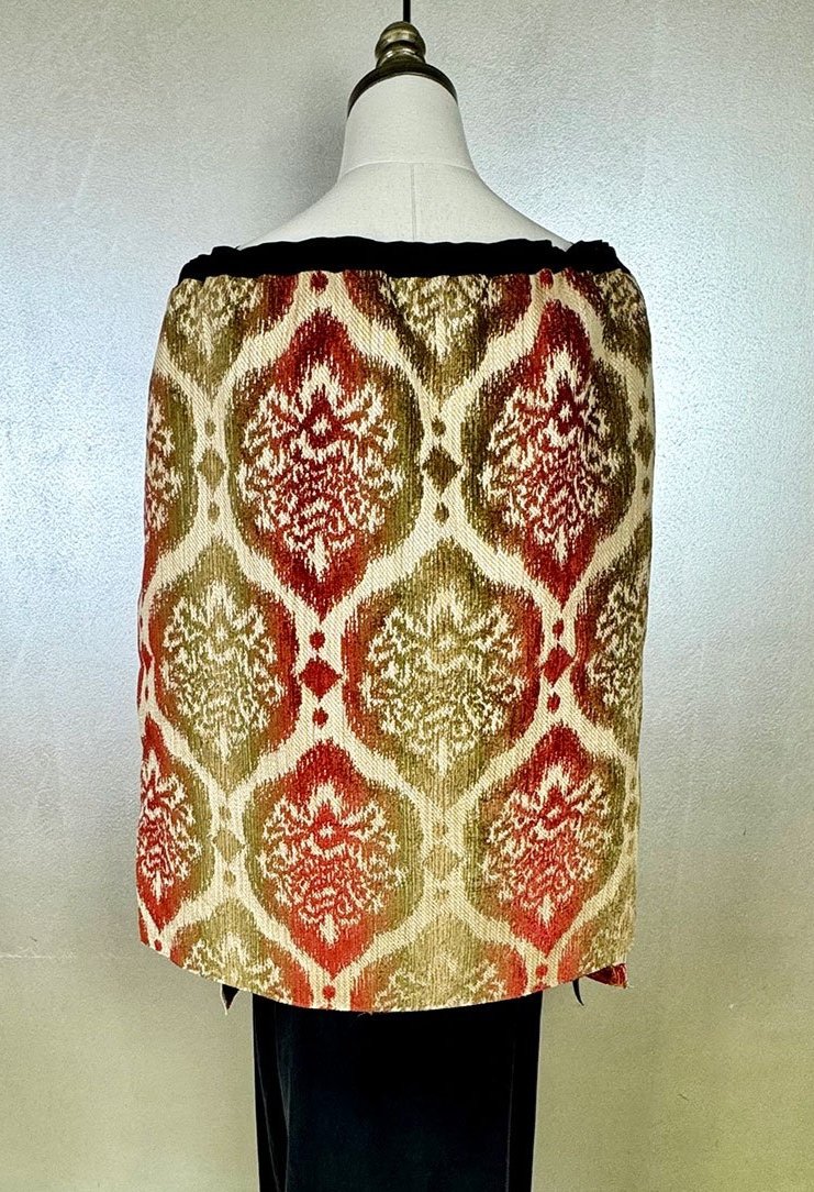 Piper overskirt on mannequin shown as cape back view with long ribbon accents