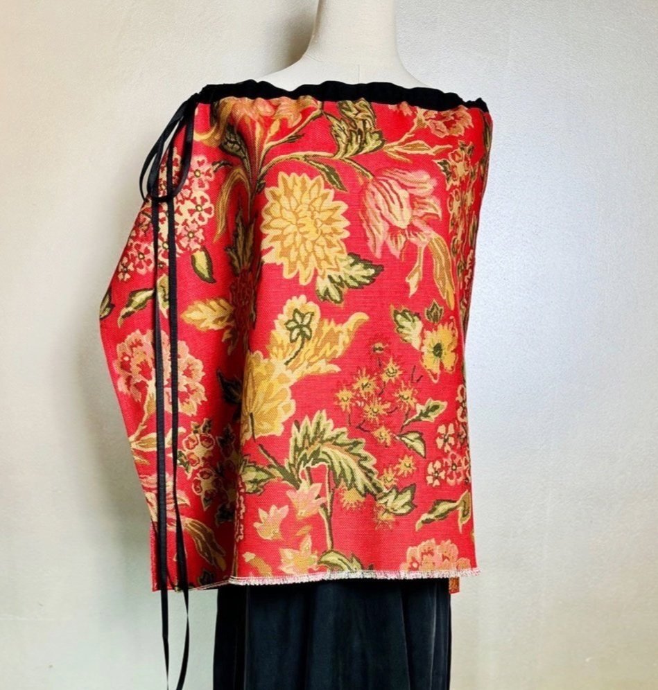 Piper overskirt on mannequin shown as cape front view with ribbon bow and swag accent