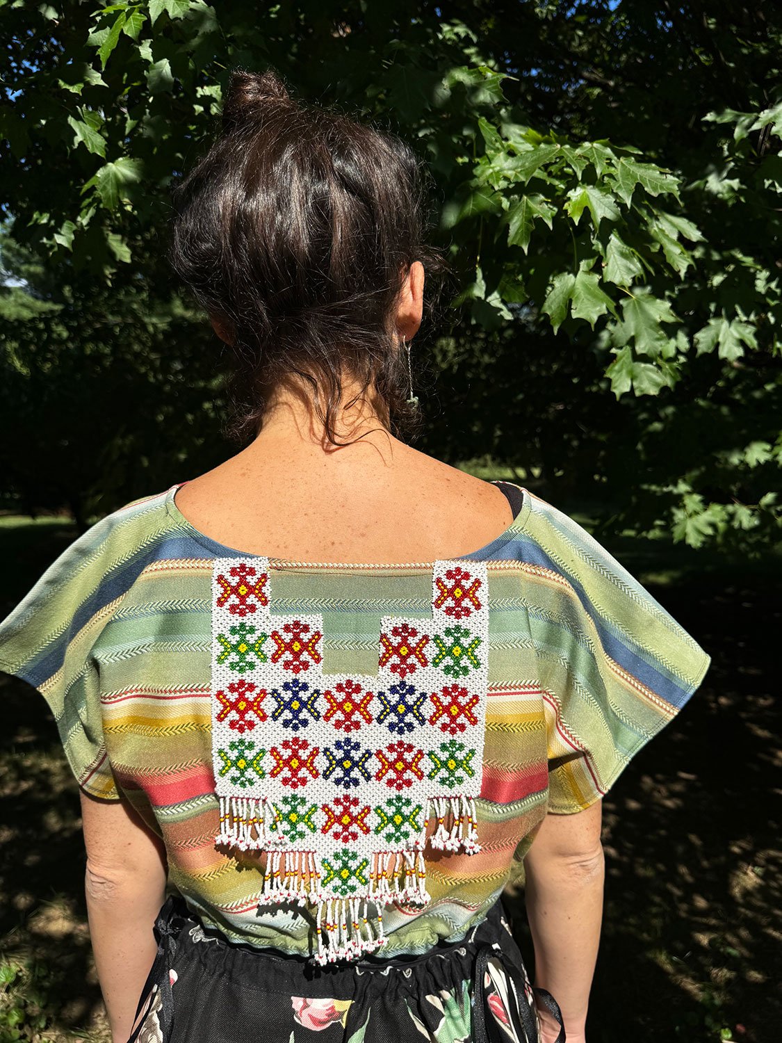 Frida Capelet with beaded antique tribal panel (close up) on model back