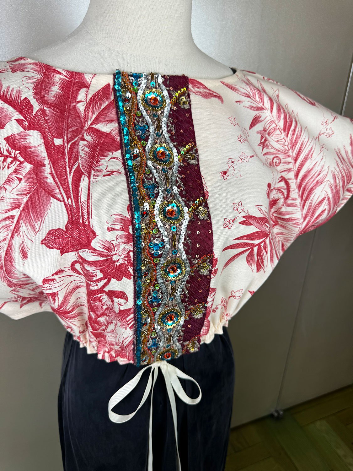 Frida Capelet shown with antique beaded deconstructed embellished Sari fragment on mannequin close up