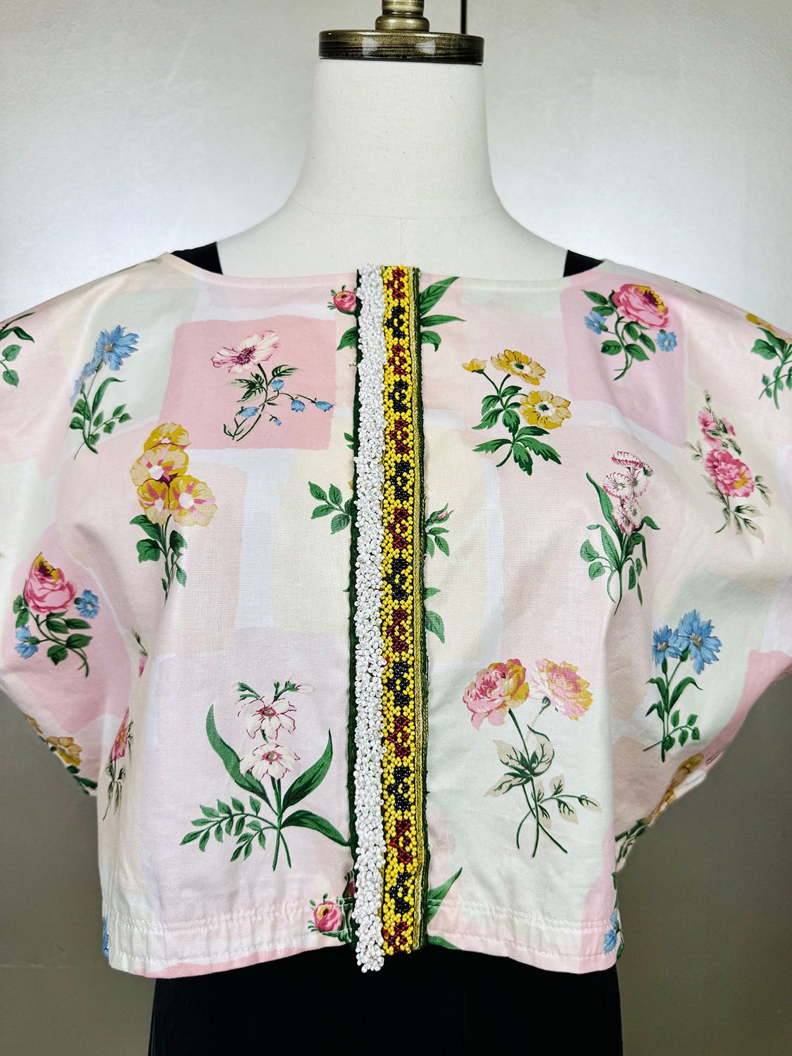 Frida Capelet pink coated chintz print with beaded tribal fragment adornment on mannequin close